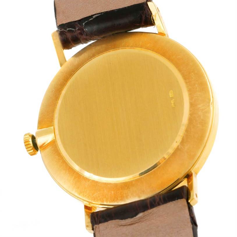 This image shows the back case and part of the strap of a Rolex Cellini 4112 Men
s Yellow Gold Champagne Dial 4112 Men
s Yellow Gold Champagne Dial watch.