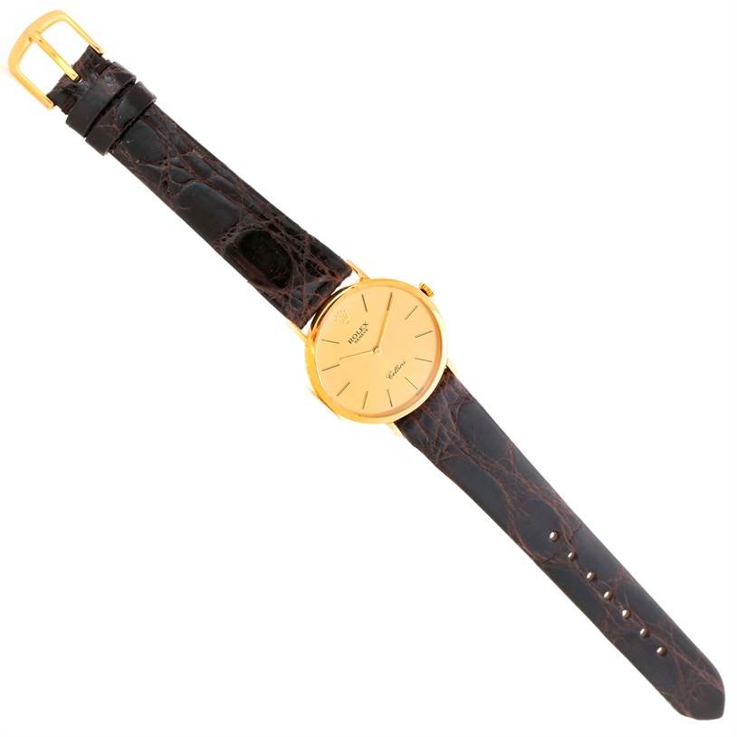 The watch is a Rolex Cellini 4112 Men
s Yellow Gold Champagne Dial 4112 Men
s Yellow Gold Champagne Dial model shown from a top-down view, displaying its face, strap, and buckle.