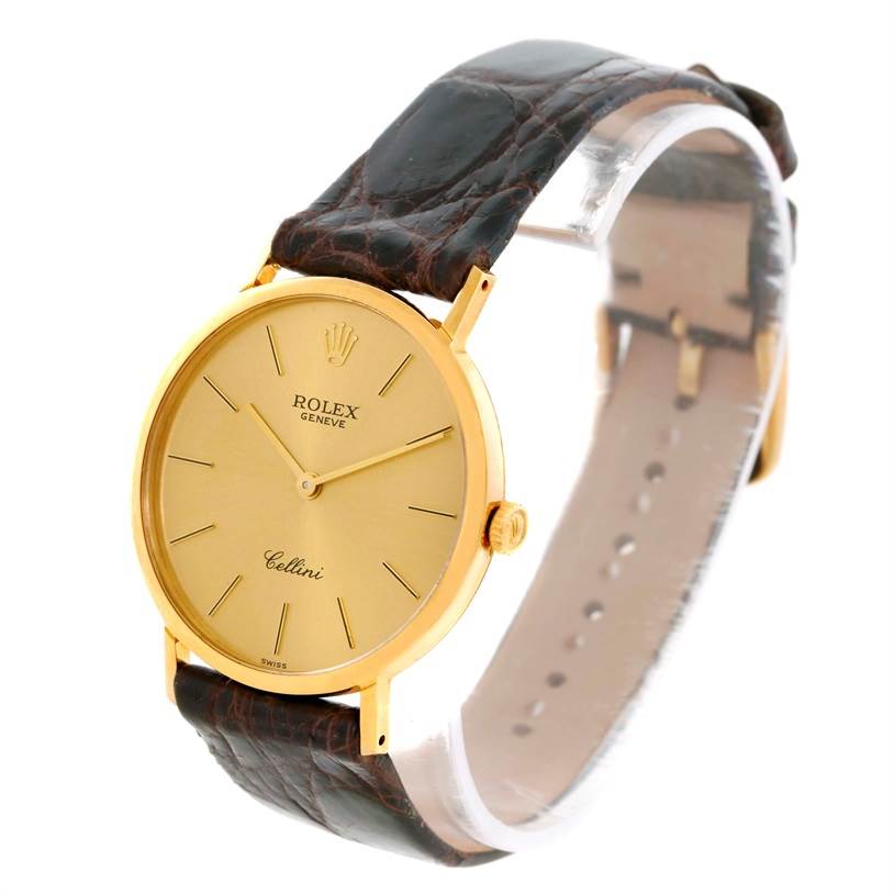 The photo shows a side view of a Rolex Cellini 4112 Men
s Yellow Gold Champagne Dial 4112 Men
s Yellow Gold Champagne Dial watch, highlighting its gold case, crown, and brown leather strap.