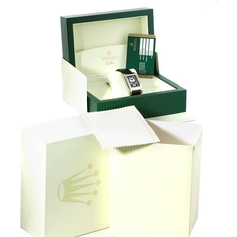 The image shows a Rolex Cellini 5443 Men's White Gold Black Dial 5443 Men's White Gold Black Dial watch in an open box with a certificate card and a white cloth beside the box.