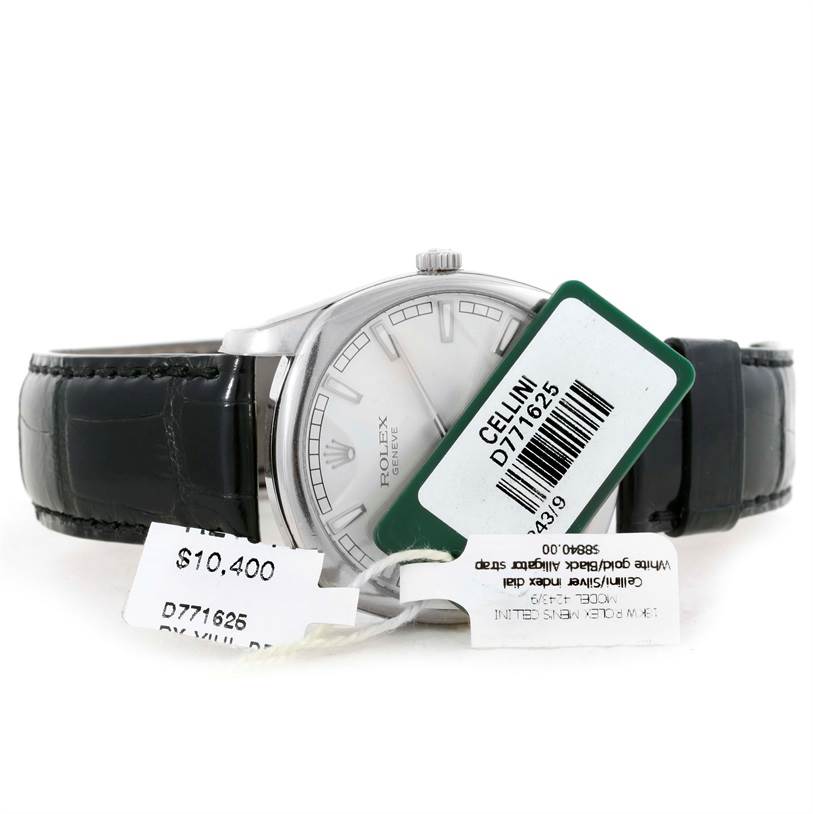 The Rolex Cellini 4243/8 Men
s White Gold Silver Dial 4243/8 Men
s White Gold Silver Dial watch is shown from the front, displaying its face with tags attached, placed on a black leather strap.