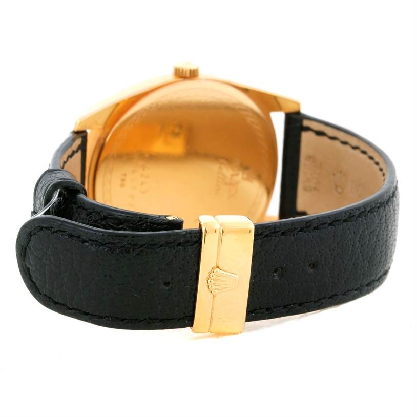 This image shows the back view of the Rolex Cellini 4243 Men's Yellow Gold Champagne Dial 4243 Men's Yellow Gold Champagne Dial watch, highlighting its gold case and black leather strap with a gold clasp.