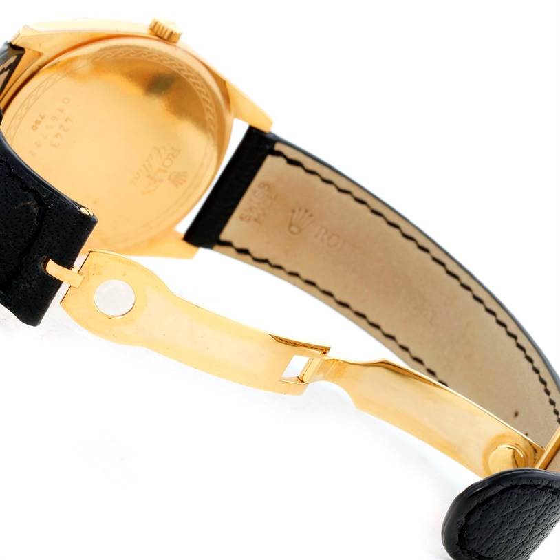 This image shows the back case and deployant clasp of a Rolex Cellini 4243 Men's Yellow Gold Champagne Dial 4243 Men's Yellow Gold Champagne Dial watch, highlighting the golden underside and leather strap.