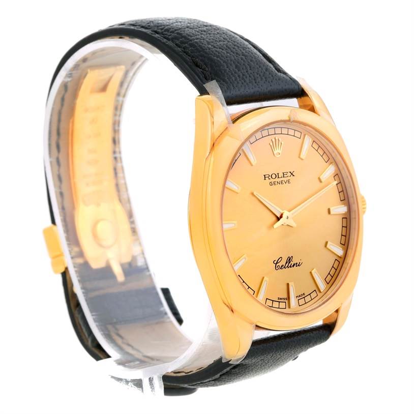 This Rolex Cellini 4243 Men's Yellow Gold Champagne Dial 4243 Men's Yellow Gold Champagne Dial watch is shown at a three-quarter angle, highlighting its gold dial, case, and black leather strap.