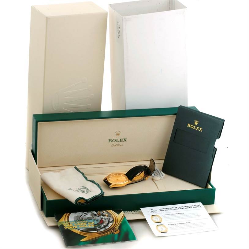 This image shows a Rolex Cellini 4243 Men's Yellow Gold Champagne Dial 4243 Men's Yellow Gold Champagne Dial watch in its original packaging, along with a pouch, manuals, and a warranty card, viewed from an angled top perspective.