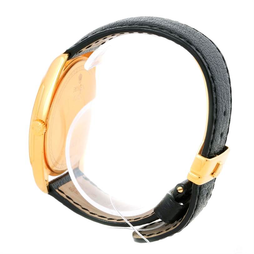 The image shows a side view of a Rolex Cellini 4243 Men's Yellow Gold Champagne Dial 4243 Men's Yellow Gold Champagne Dial watch, focusing on the case and leather strap with a gold buckle.