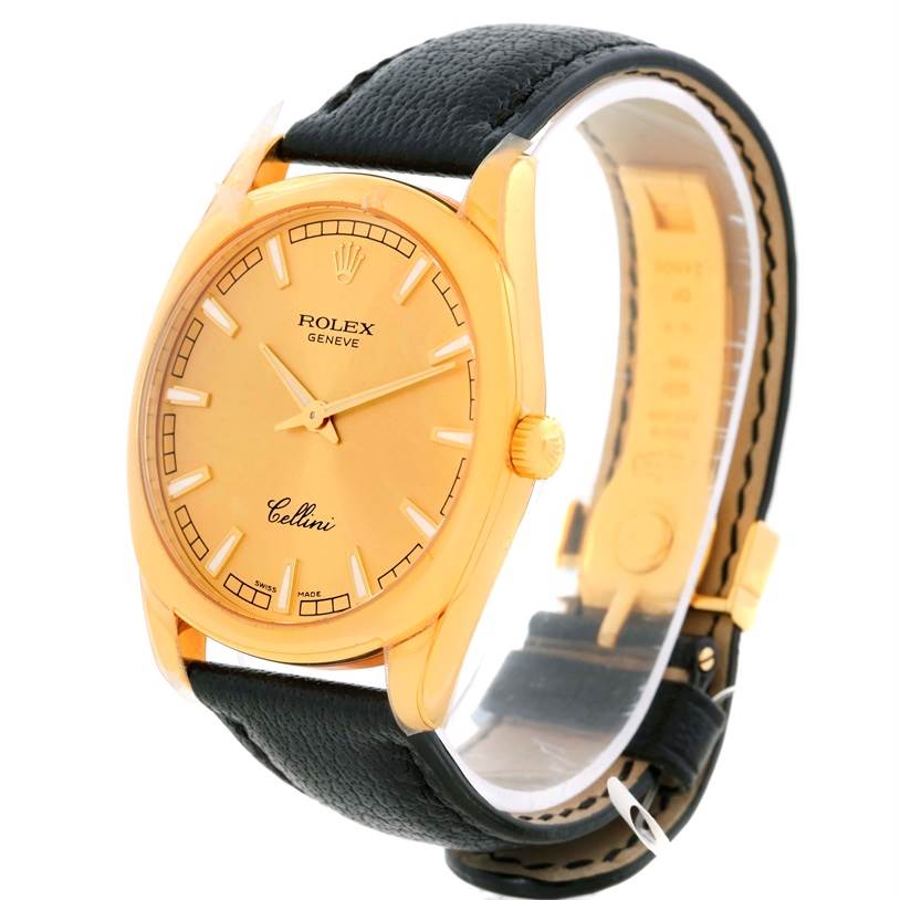 The Rolex Cellini 4243 Men's Yellow Gold Champagne Dial 4243 Men's Yellow Gold Champagne Dial watch is shown at a front-side angle, highlighting its gold dial, black leather strap, and side crown.