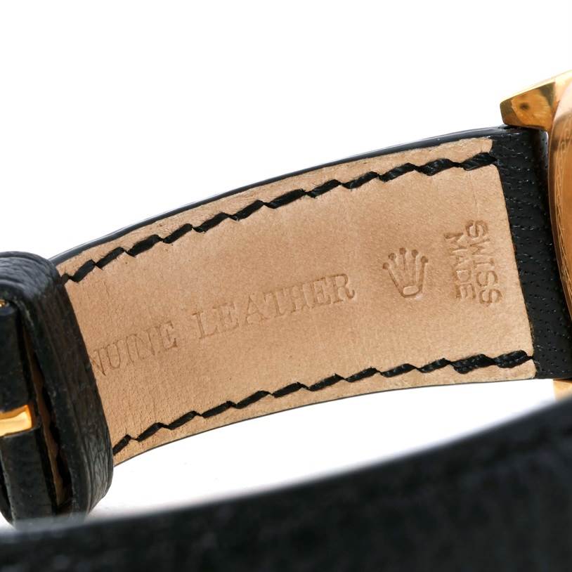 The image shows a close-up of the leather strap and part of the buckle of a Rolex Cellini 4243 Men's Yellow Gold Champagne Dial 4243 Men's Yellow Gold Champagne Dial watch.