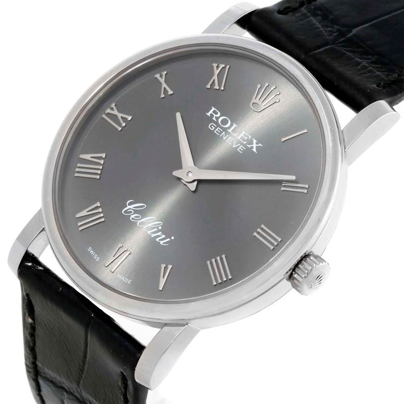 The image shows a close-up view of a Rolex Cellini 5115 Men's White Gold Grey Dial 5115 Men's White Gold Grey Dial watch, featuring its dial, case, crown, and part of the black strap.