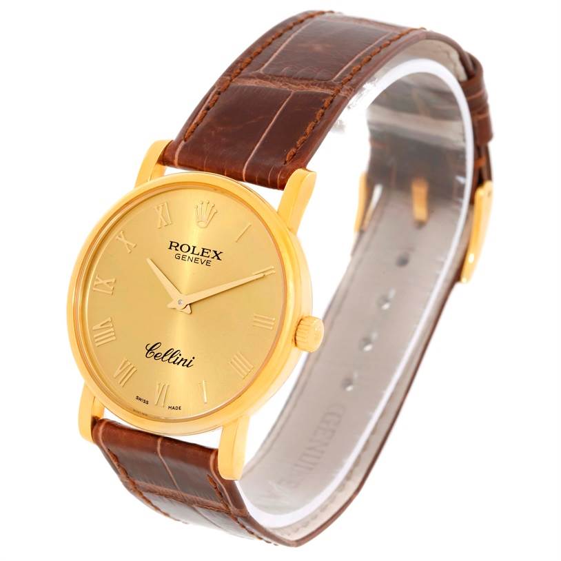 The Rolex Cellini 5115 Men
s Yellow Gold Champagne Dial 5115 Men
s Yellow Gold Champagne Dial watch is shown at a slight angle, highlighting its gold case, brown leather strap, and roman numeral dial.