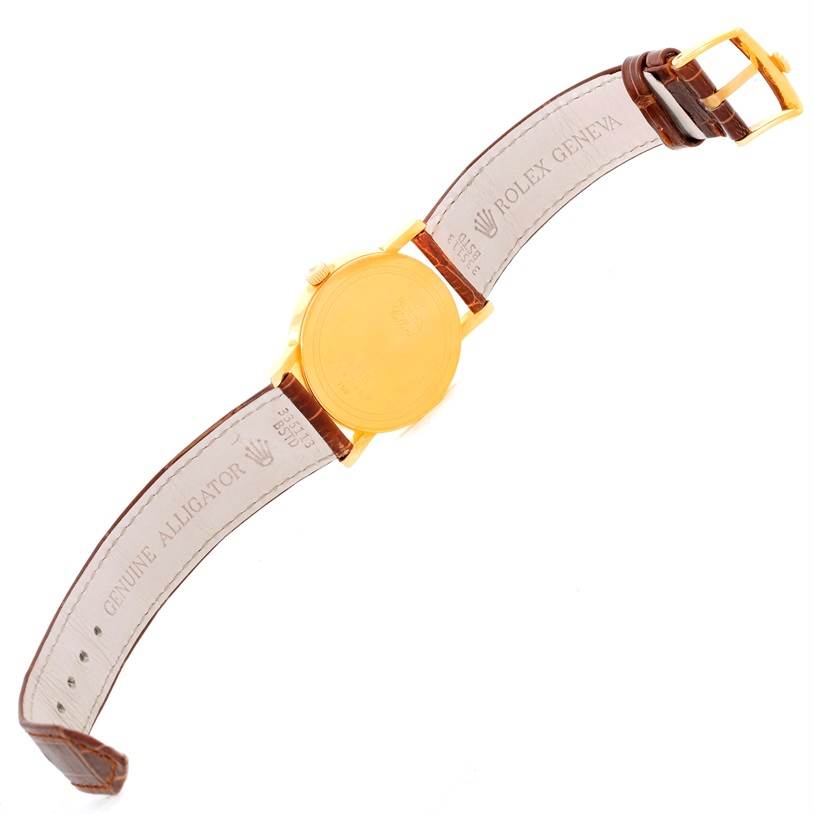 The image shows the back view of a Rolex Cellini 5115 Men
s Yellow Gold Champagne Dial 5115 Men
s Yellow Gold Champagne Dial watch, highlighting the case back, leather strap, and buckle.