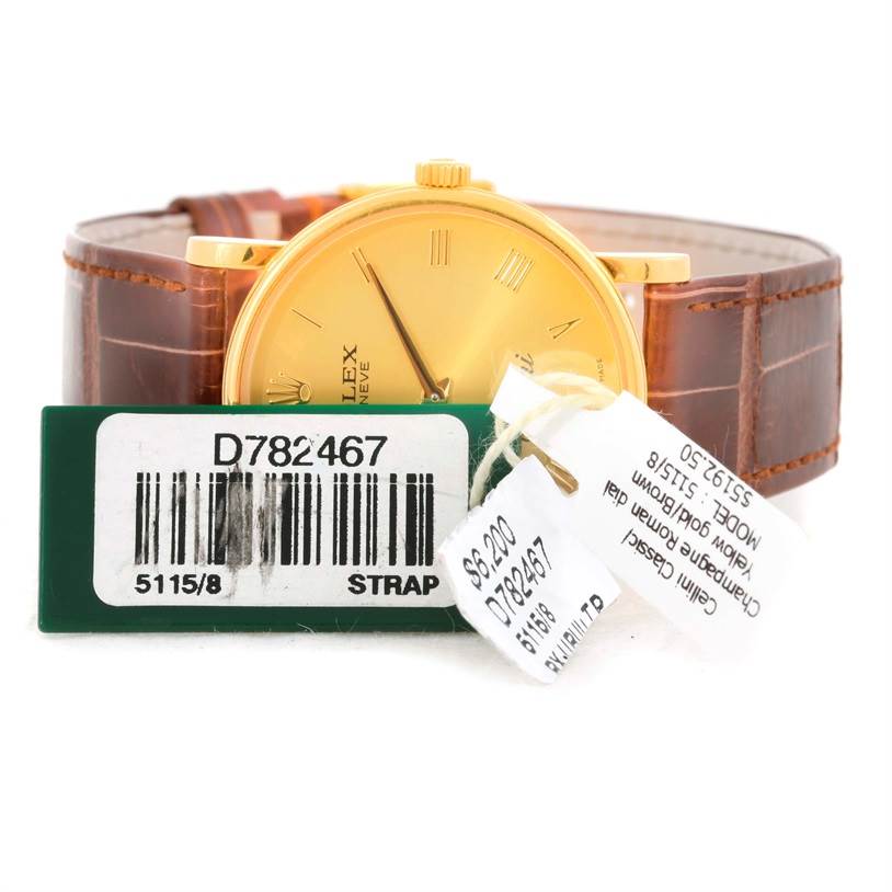 The Rolex Cellini 5115 Men
s Yellow Gold Champagne Dial 5115 Men
s Yellow Gold Champagne Dial watch is shown from a front angle, displaying its dial, crown, and brown leather strap, along with price tags.