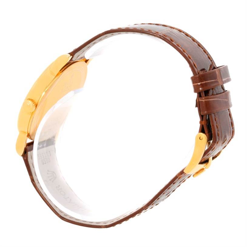 The image shows a side view of a Rolex Cellini 5115 Men
s Yellow Gold Champagne Dial 5115 Men
s Yellow Gold Champagne Dial watch, highlighting its brown leather strap and gold case.