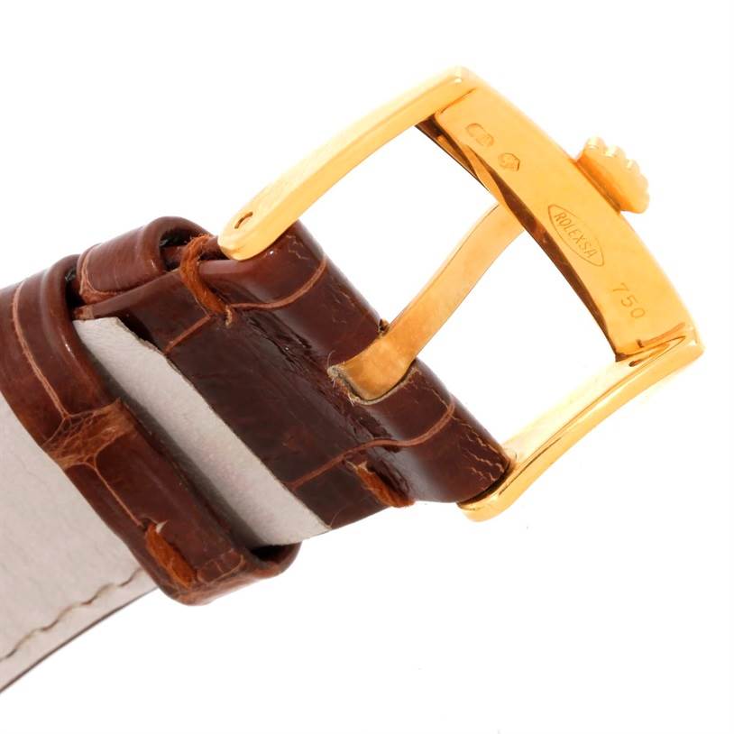 The image shows a close-up of the gold buckle and brown leather strap of a Rolex Cellini 5115 Men
s Yellow Gold Champagne Dial 5115 Men
s Yellow Gold Champagne Dial watch.