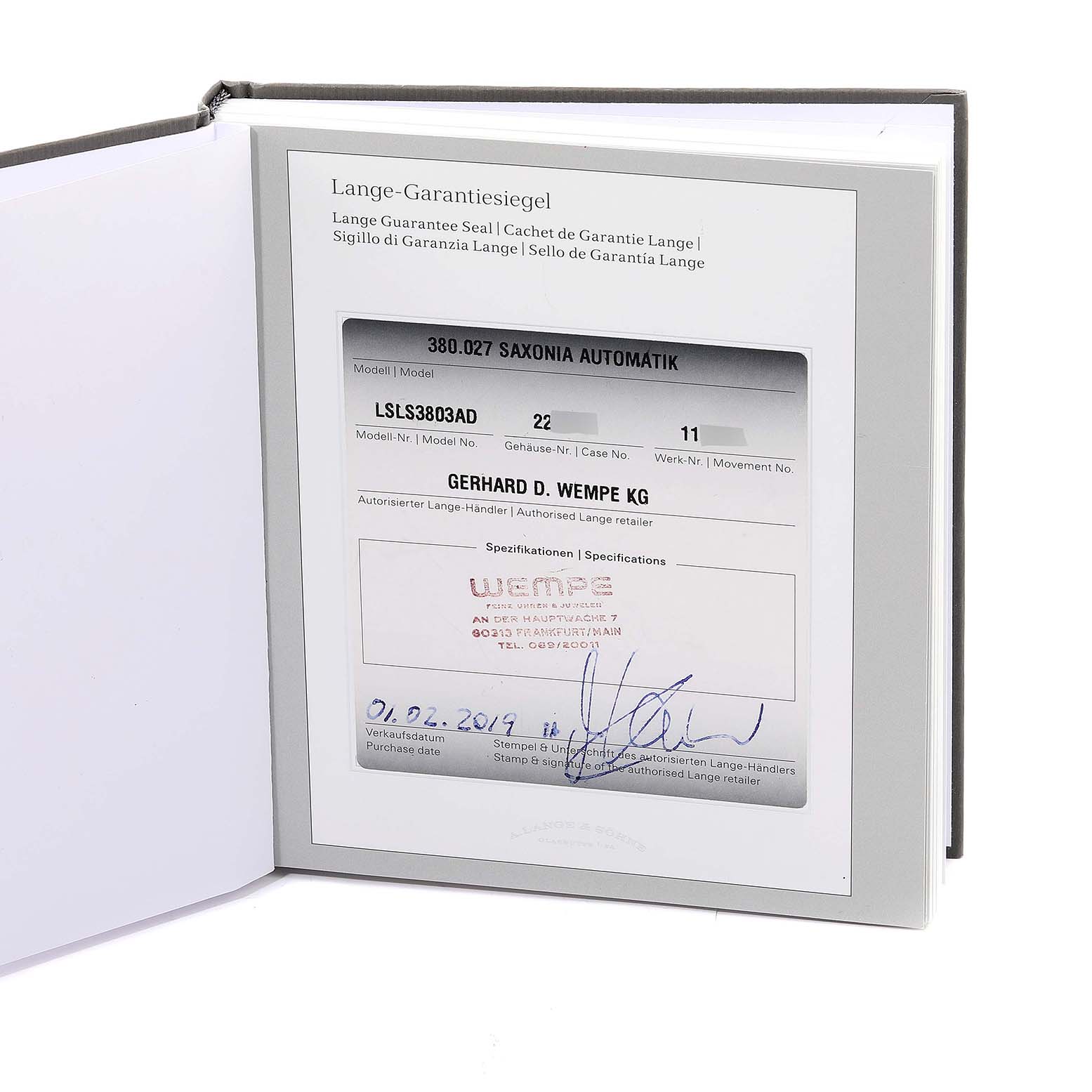 The image shows the warranty card of an A. Lange & Sohne Saxonia 380.027 Men's White Gold Silver Dial watch.