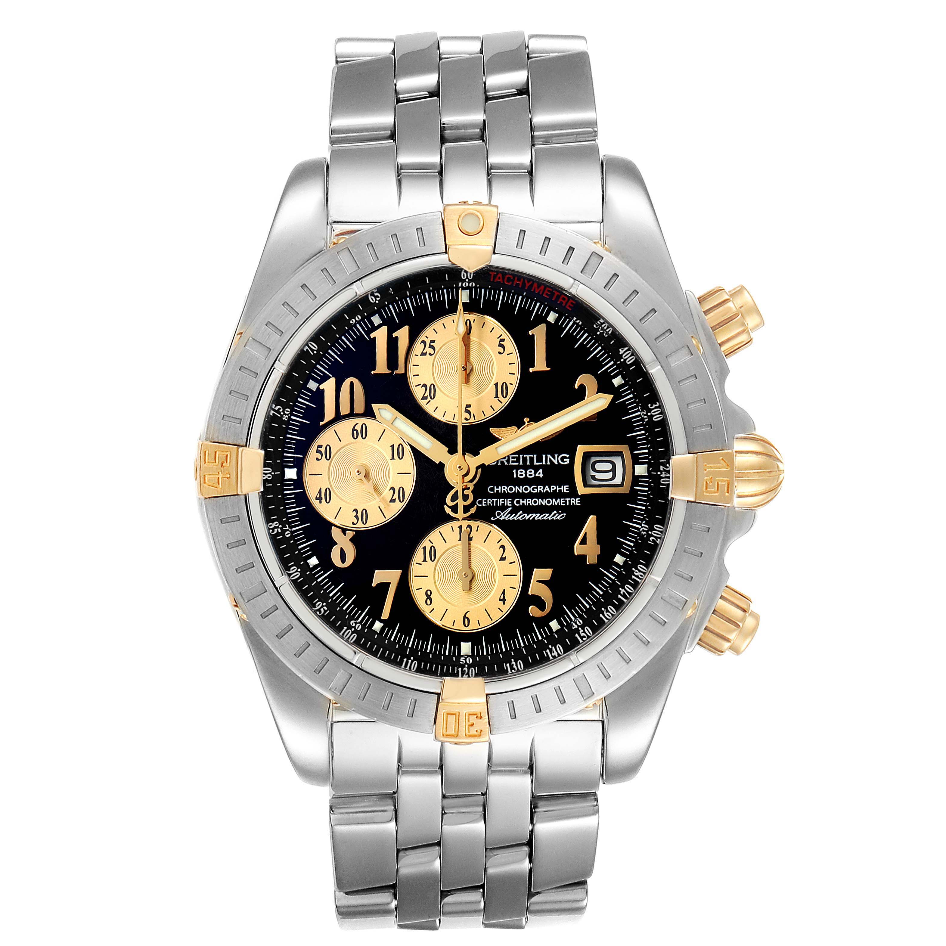 The image shows a front view of a Breitling Chronomat B13356 Men
s Stainless Steel Black Dial B13356 Men
s Stainless Steel Black Dial watch with a silver and gold bracelet, black dial, and gold subdials.