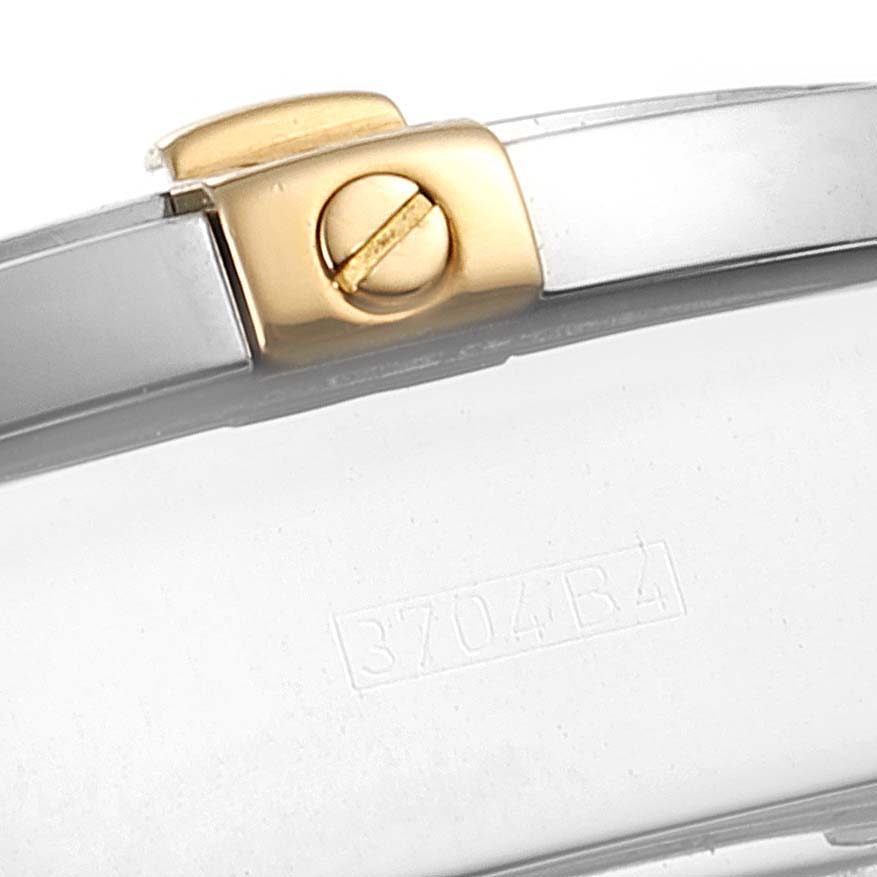 The image shows a close-up of the clasp and a section of the band of a Breitling Chronomat B13356 Men
s Stainless Steel Black Dial B13356 Men
s Stainless Steel Black Dial watch, featuring a two-tone design.