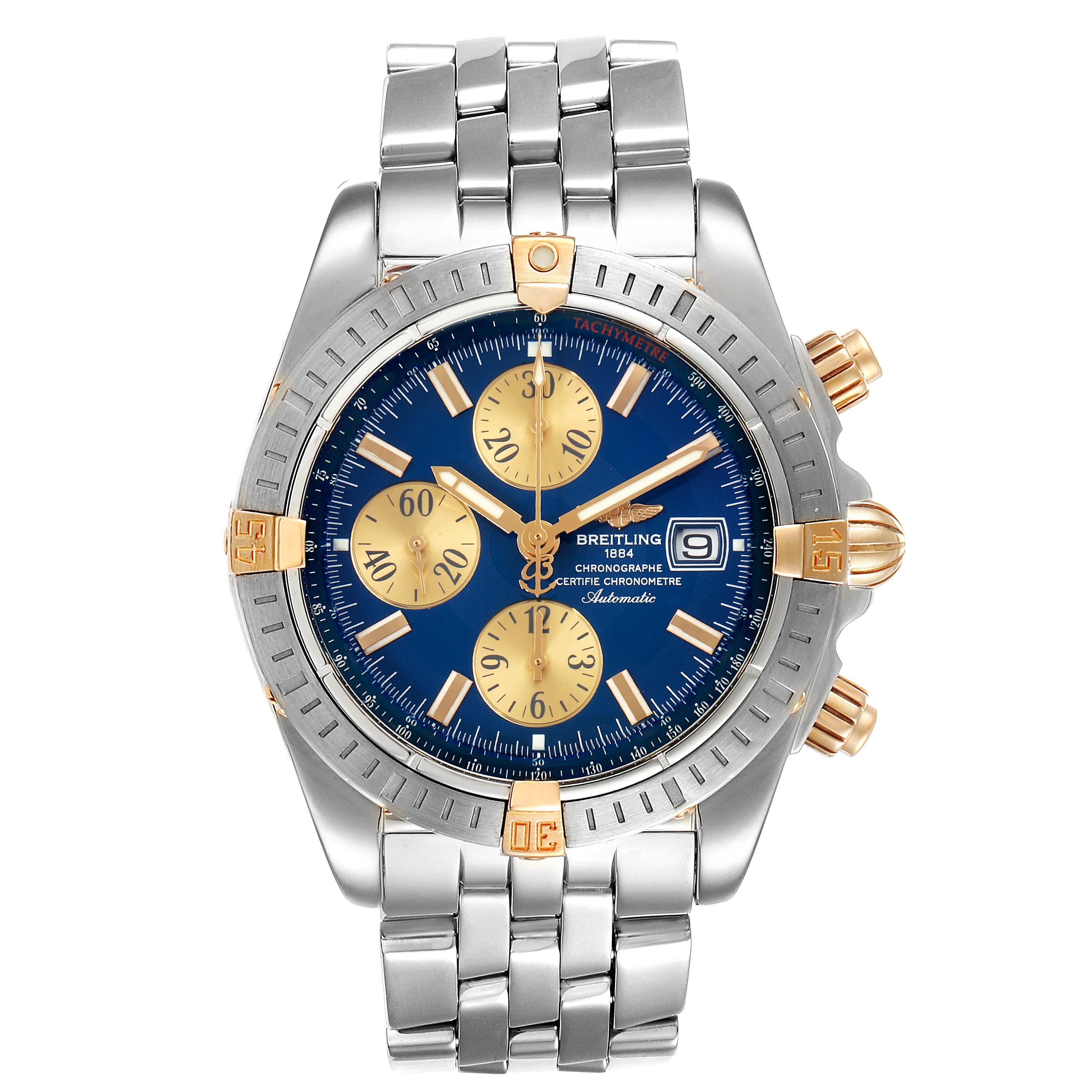 The image shows a front view of the Breitling Chronomat B13356 Men
s Stainless Steel Blue Dial B13356 Men
s Stainless Steel Blue Dial watch, highlighting its blue dial, gold subdials, and metal bracelet.