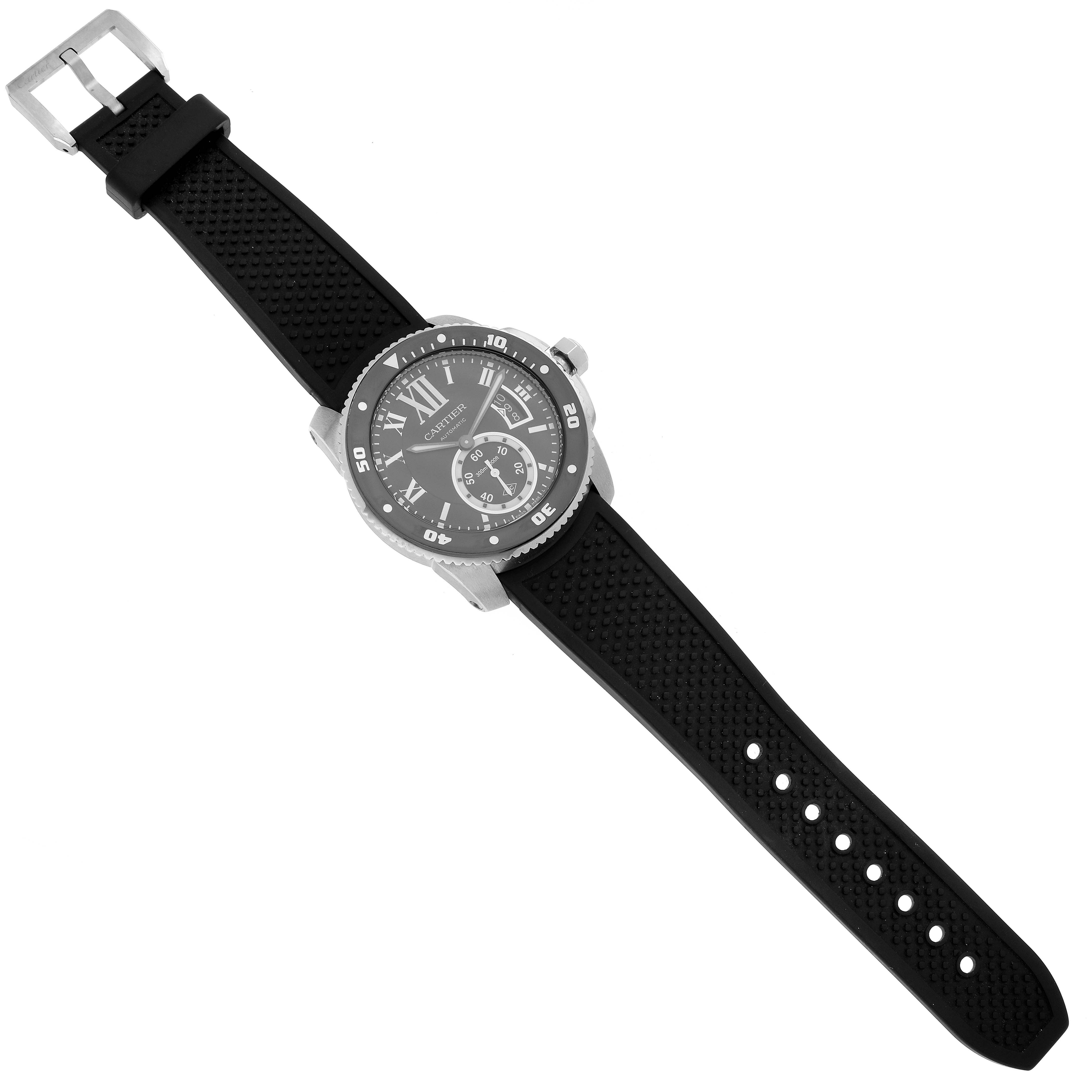 The image shows a top view of a Calibre de Cartier watch by Cartier, highlighting the watch face, bezel, and strap.