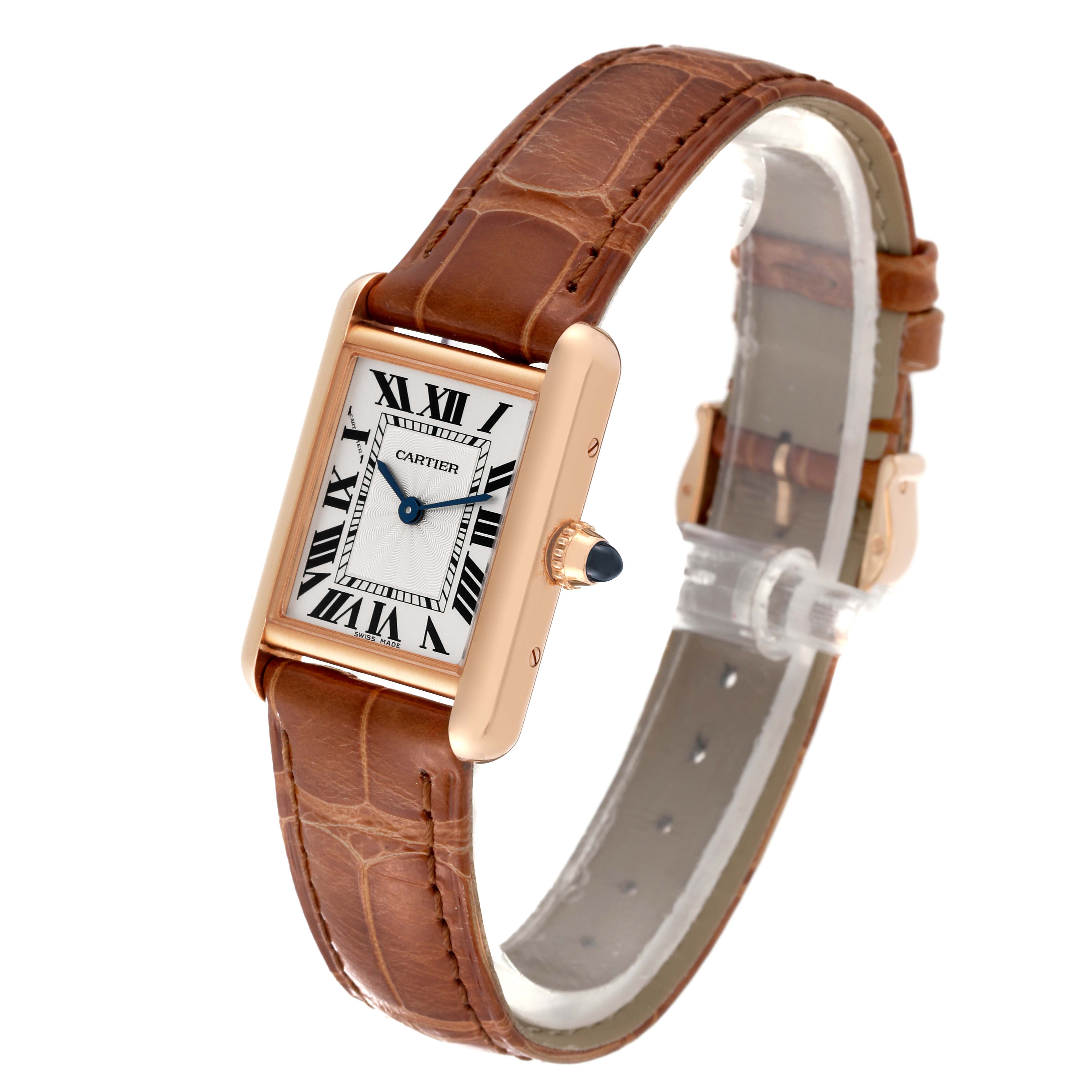 This image shows a Cartier Tank Louis WGTA0010 Women
s Rose Gold Silver Dial WGTA0010 Women
s Rose Gold Silver Dial watch from a slight side angle, highlighting its rectangular face, Roman numerals, and brown leather strap.