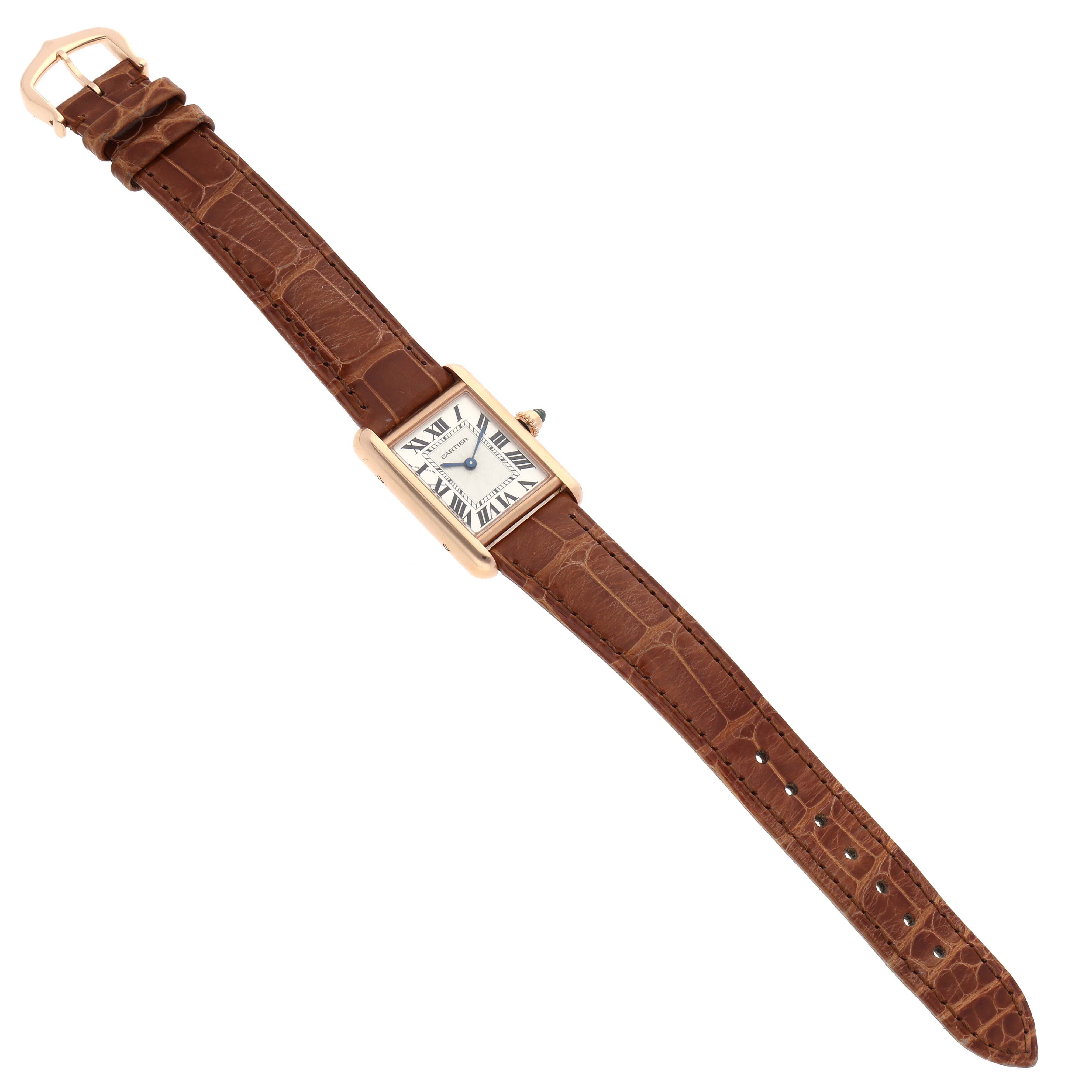 The image shows a top-down view of a Cartier Tank Louis WGTA0010 Women
s Rose Gold Silver Dial WGTA0010 Women
s Rose Gold Silver Dial watch with a brown leather strap and a rectangular face displaying Roman numerals.