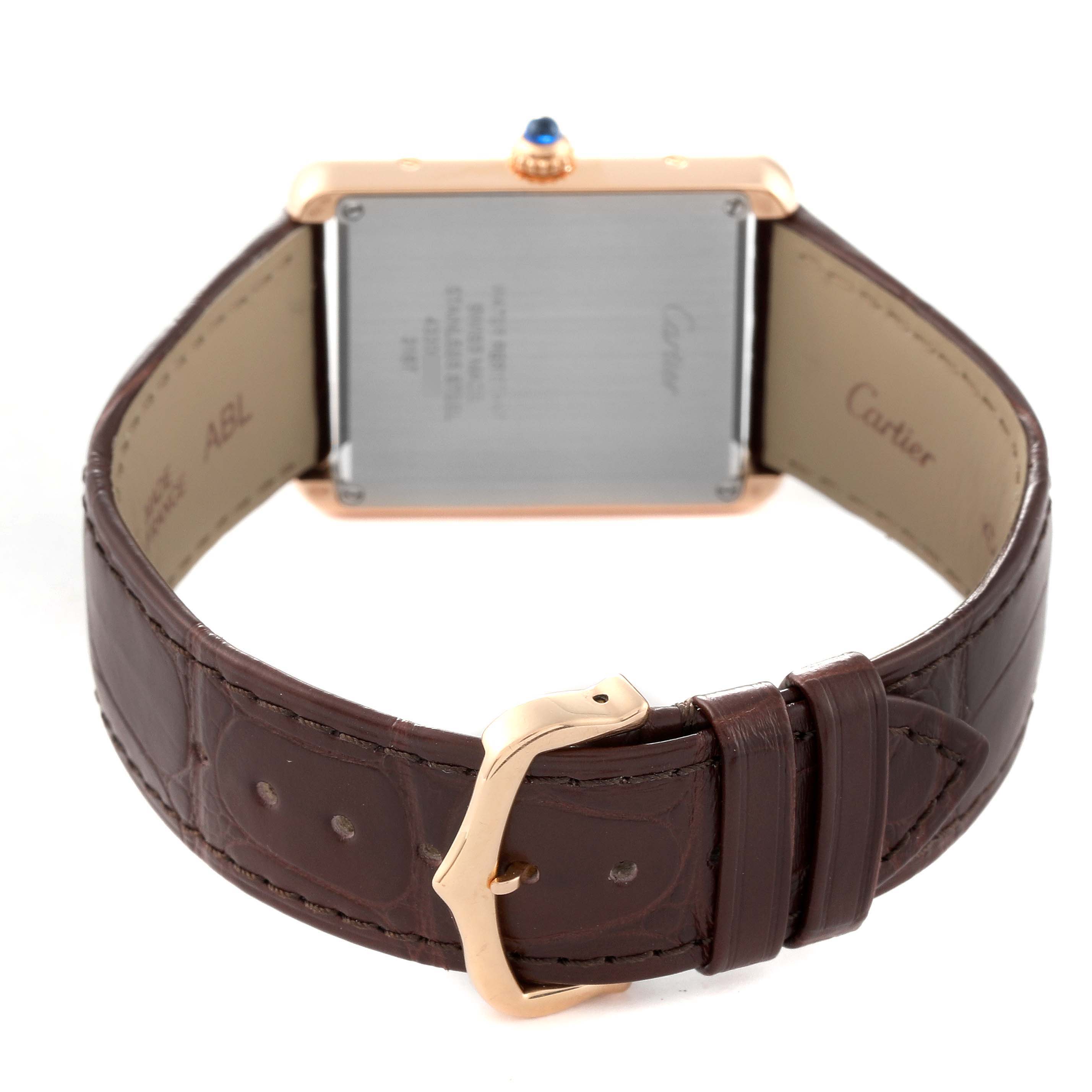 This image shows the back view of a Cartier Tank Solo W5200025 Men
s Steel and Gold (two tone) Silver Dial W5200025 Men
s Steel and Gold (two tone) Silver Dial watch, focusing on its case back, brown leather strap, and gold buckle.