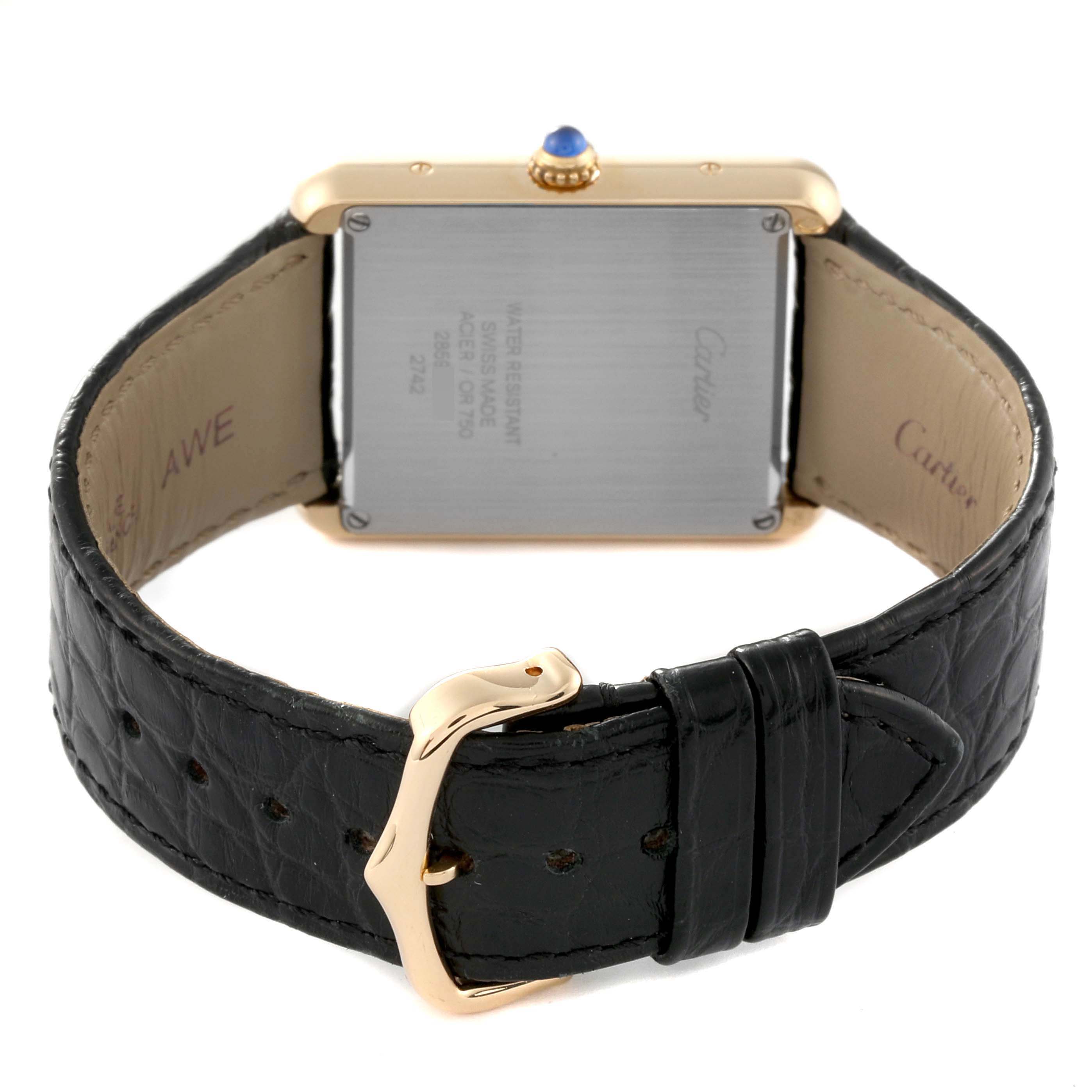 The image shows the backside of a Cartier Tank Solo W1018855 Men
s Steel and Gold (two tone) Silver Dial W1018855 Men
s Steel and Gold (two tone) Silver Dial watch, featuring its leather strap and clasp.