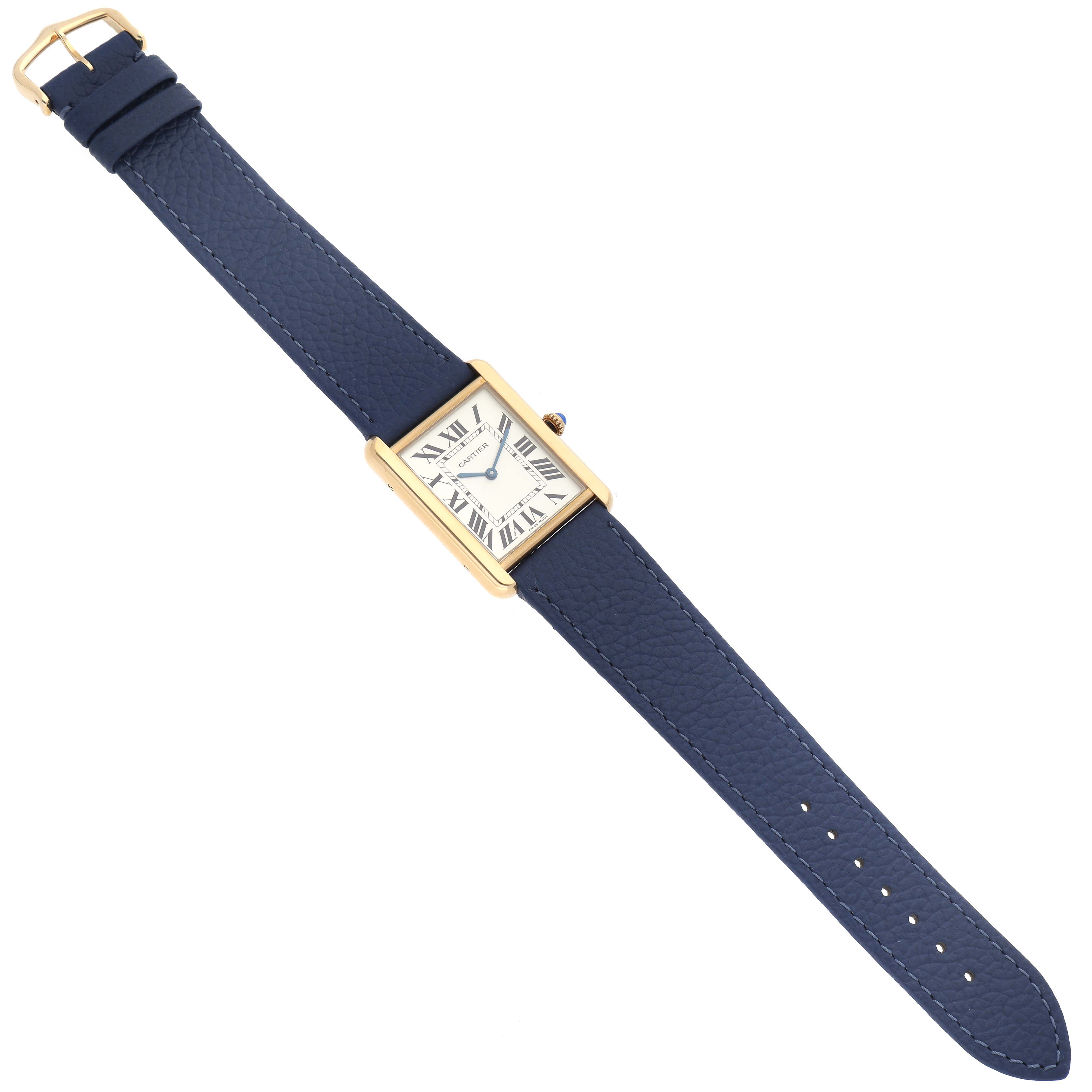 The Cartier Tank Solo W1018855 Men
s Steel and Gold (two tone) Silver Dial W1018855 Men
s Steel and Gold (two tone) Silver Dial watch is shown laid flat, displaying its rectangular face, blue leather strap, and gold case.