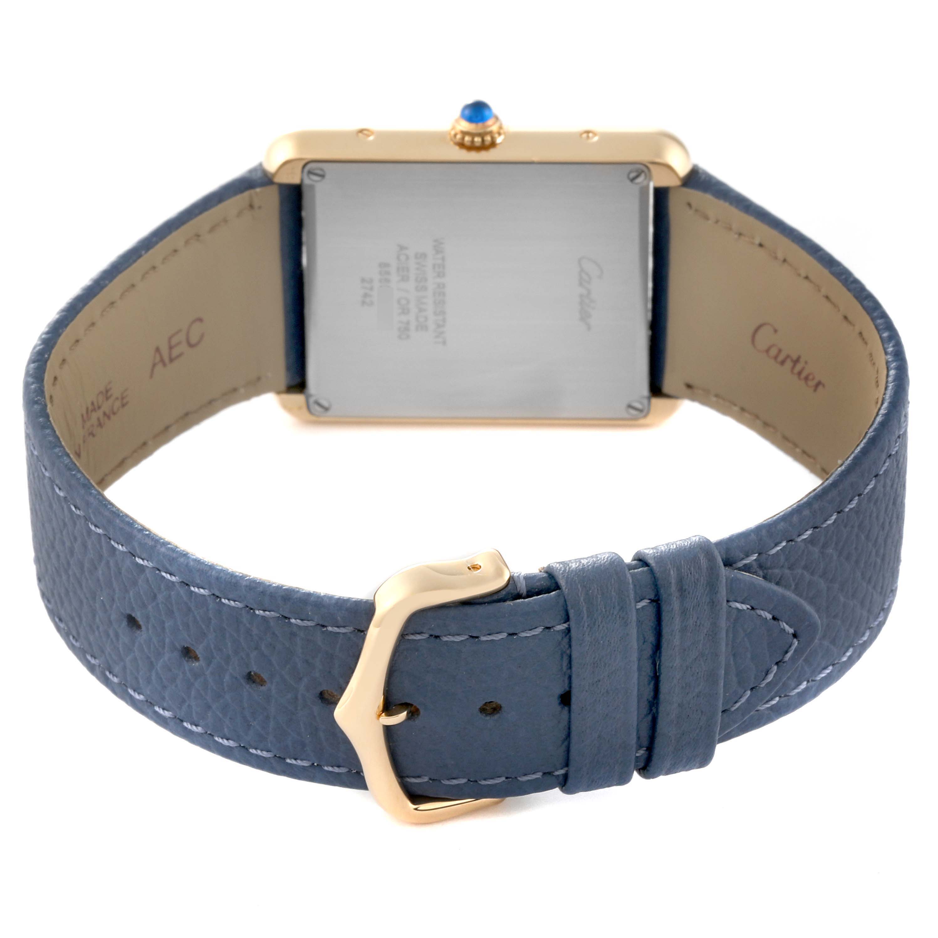 The image shows the back view of a Cartier Tank Solo W1018855 Men
s Steel and Gold (two tone) Silver Dial W1018855 Men
s Steel and Gold (two tone) Silver Dial watch, highlighting the case back, blue leather strap, and buckle.