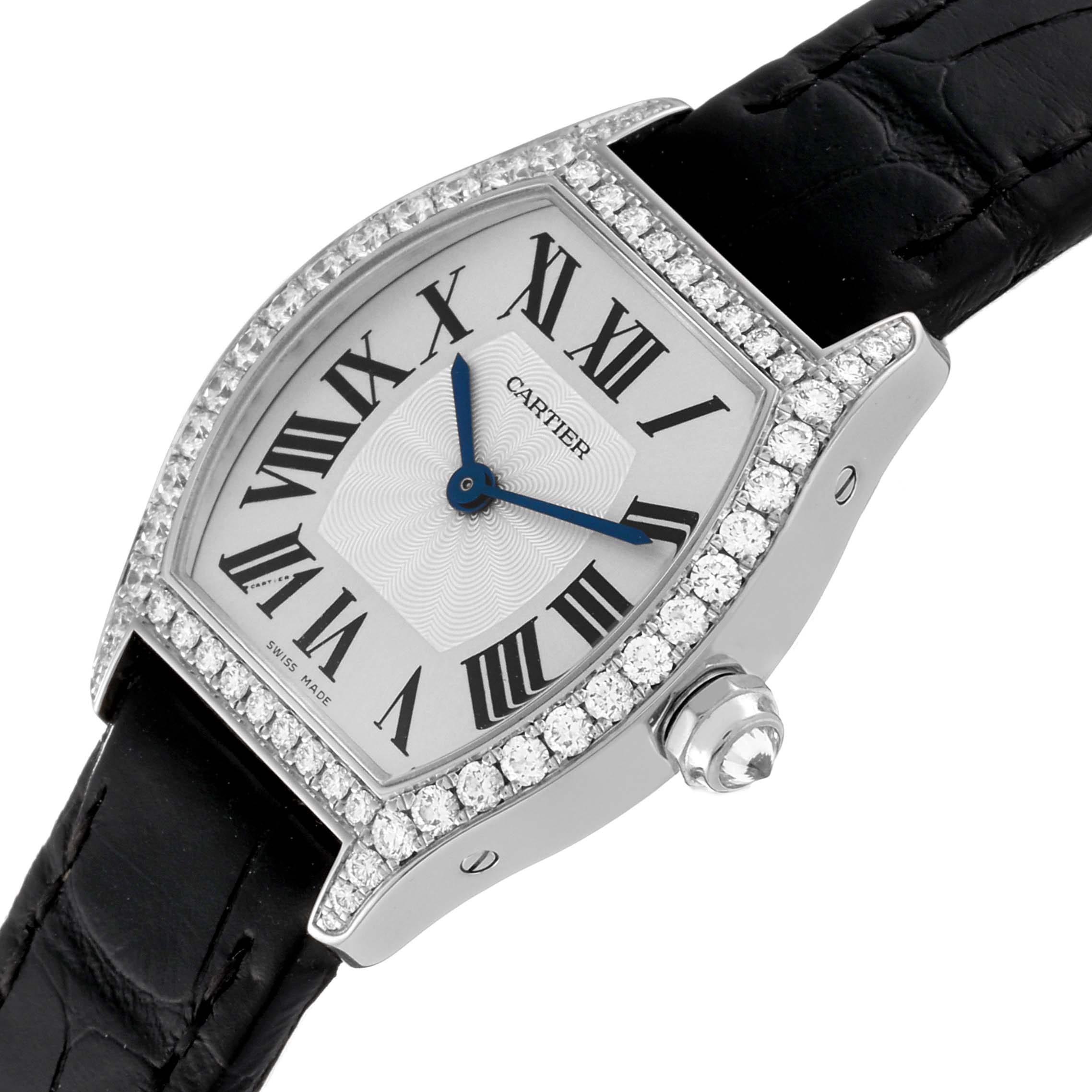 The Cartier Tortue WA501007 Women's White Gold Silver Dial WA501007 Women's White Gold Silver Dial watch is shown from an angled top view, highlighting the face, diamond bezel, crown, and part of the black strap.