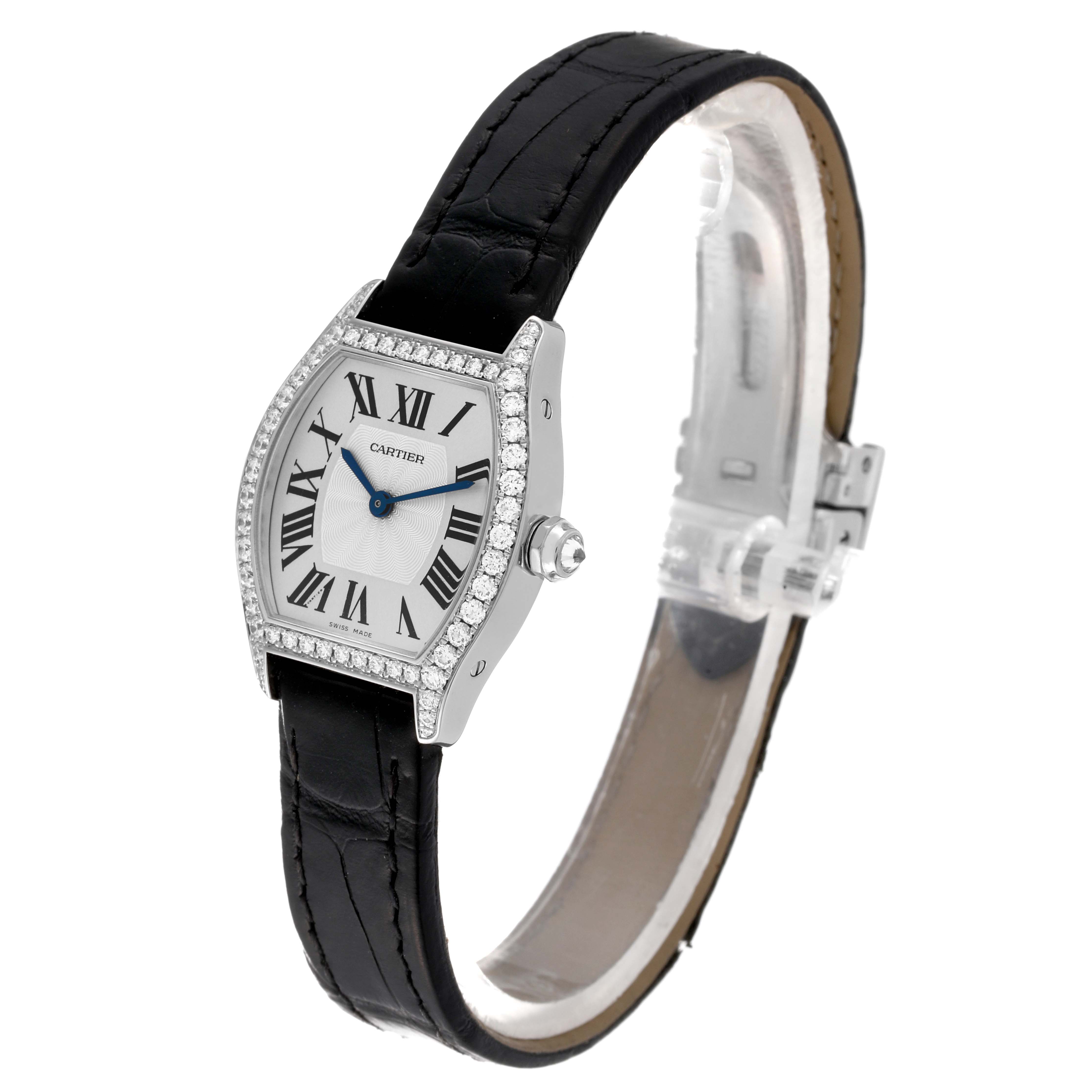 The Cartier Tortue WA501007 Women's White Gold Silver Dial WA501007 Women's White Gold Silver Dial watch is shown tilted slightly to the left, displaying its face, strap, and bejeweled bezel.