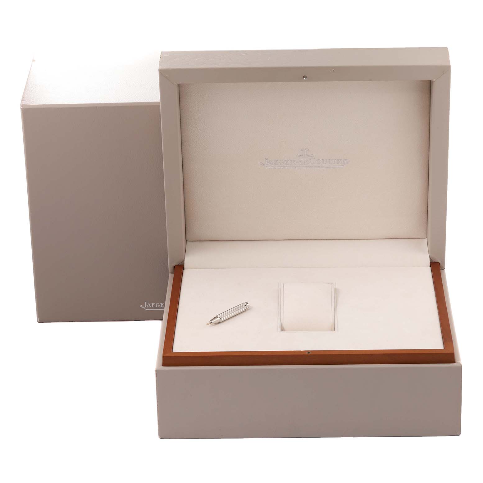 The image shows an open Jaeger LeCoultre Reverso Q3748421 Men's Stainless Steel Silver Dial Q3748421 Men's Stainless Steel Silver Dial watch box, displaying an inner cushion and a small tool.