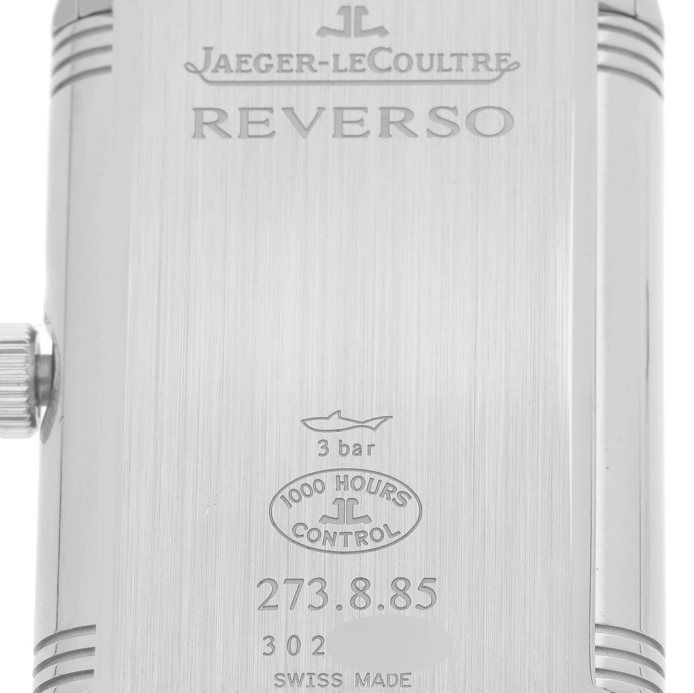 This image shows the back of the Jaeger-LeCoultre Reverso watch, including the crown and engraved details.