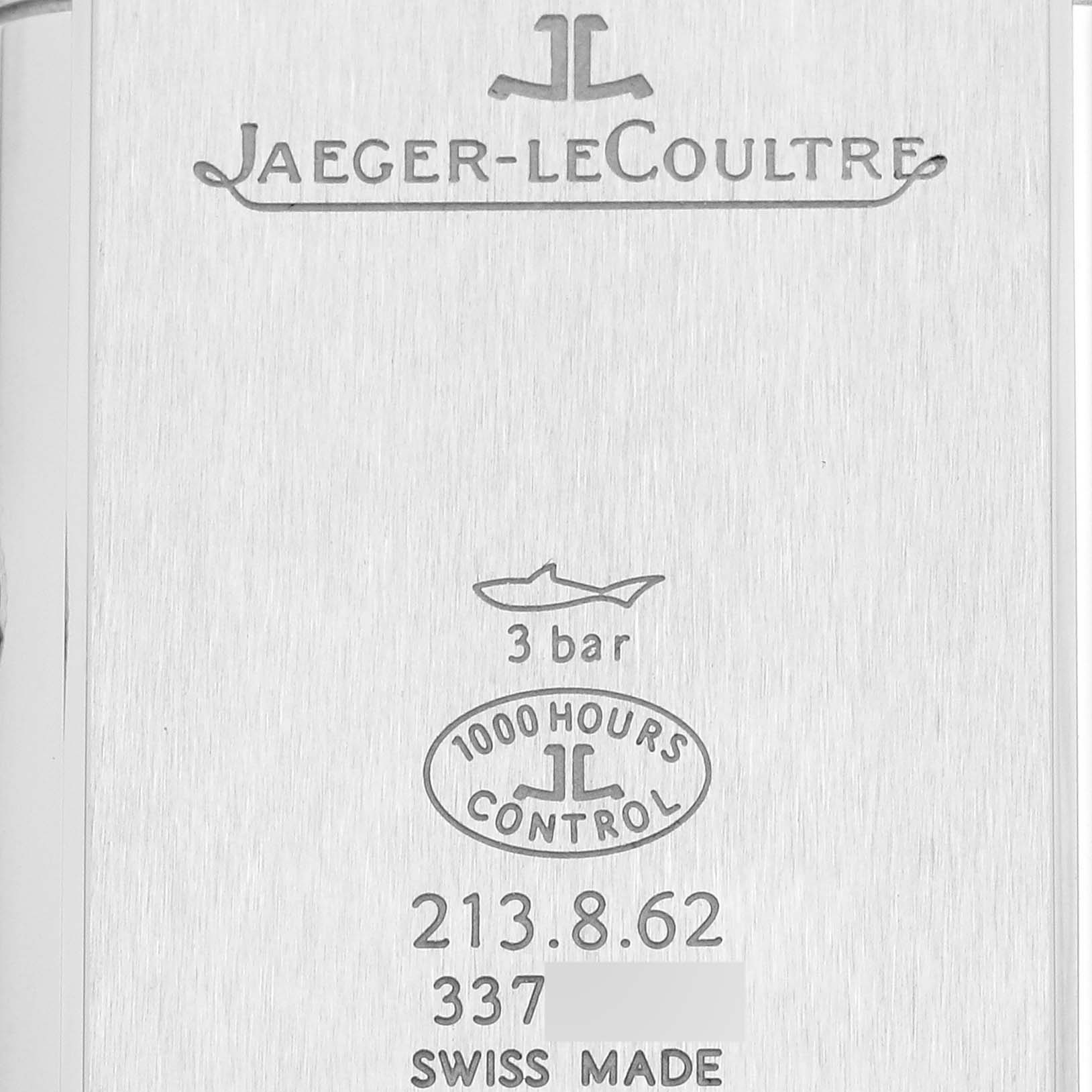 This image shows the back of a Jaeger-LeCoultre Reverso watch, featuring model details and certification engravings.