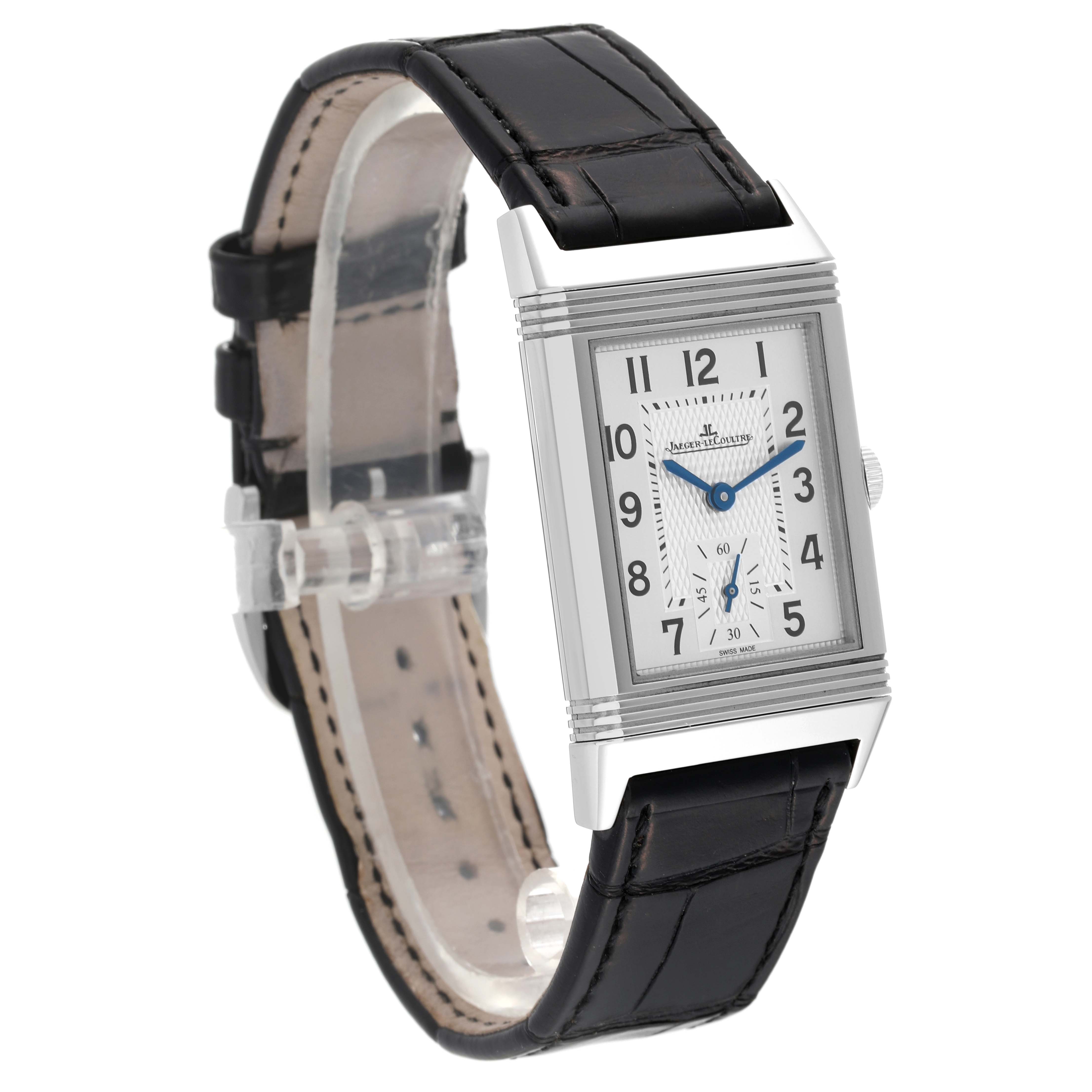 The Jaeger LeCoultre Reverso Q2438520 Men's Stainless Steel Silver Dial Q2438520 Men's Stainless Steel Silver Dial watch is shown at an angle displaying its rectangular face, dial, leather strap, and buckle.