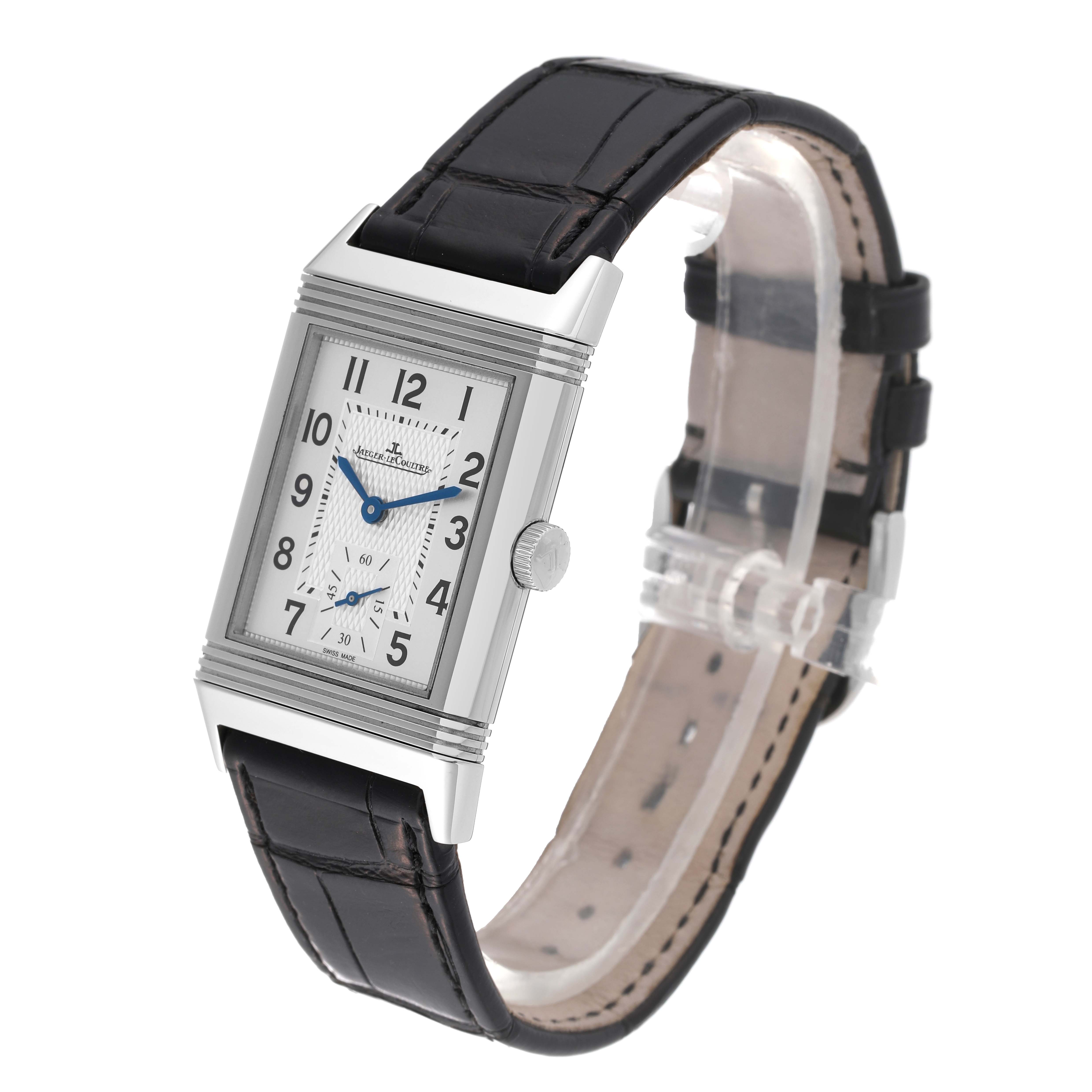 This image shows a Jaeger LeCoultre Reverso Q2438520 Men's Stainless Steel Silver Dial Q2438520 Men's Stainless Steel Silver Dial watch from a 3/4 angle, highlighting its rectangular case, dial, and leather strap.