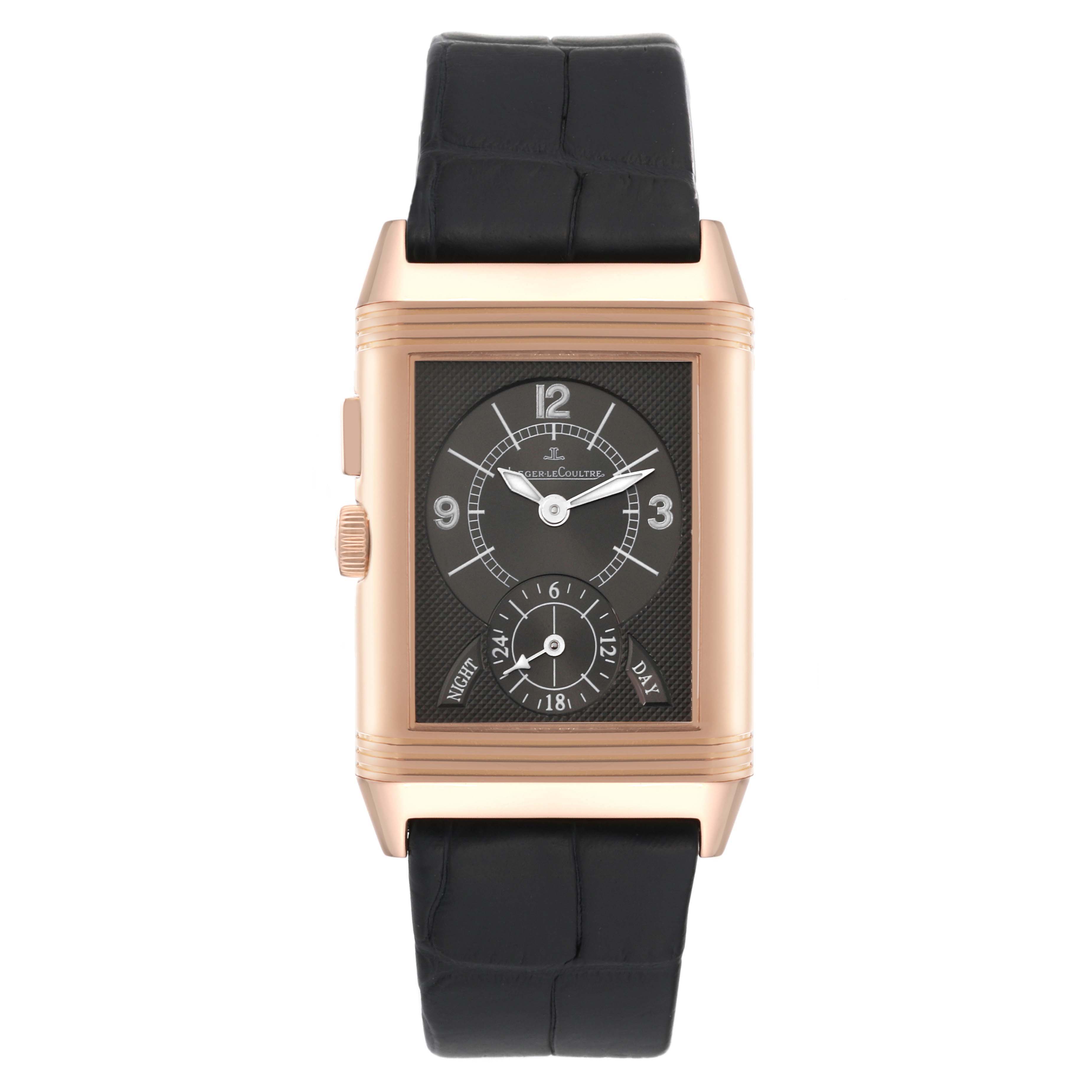 The image shows a front view of a Jaeger LeCoultre Reverso Q2712410 Men
s Rose Gold Silver Dial Q2712410 Men
s Rose Gold Silver Dial watch with a rectangular dial and black leather strap.
