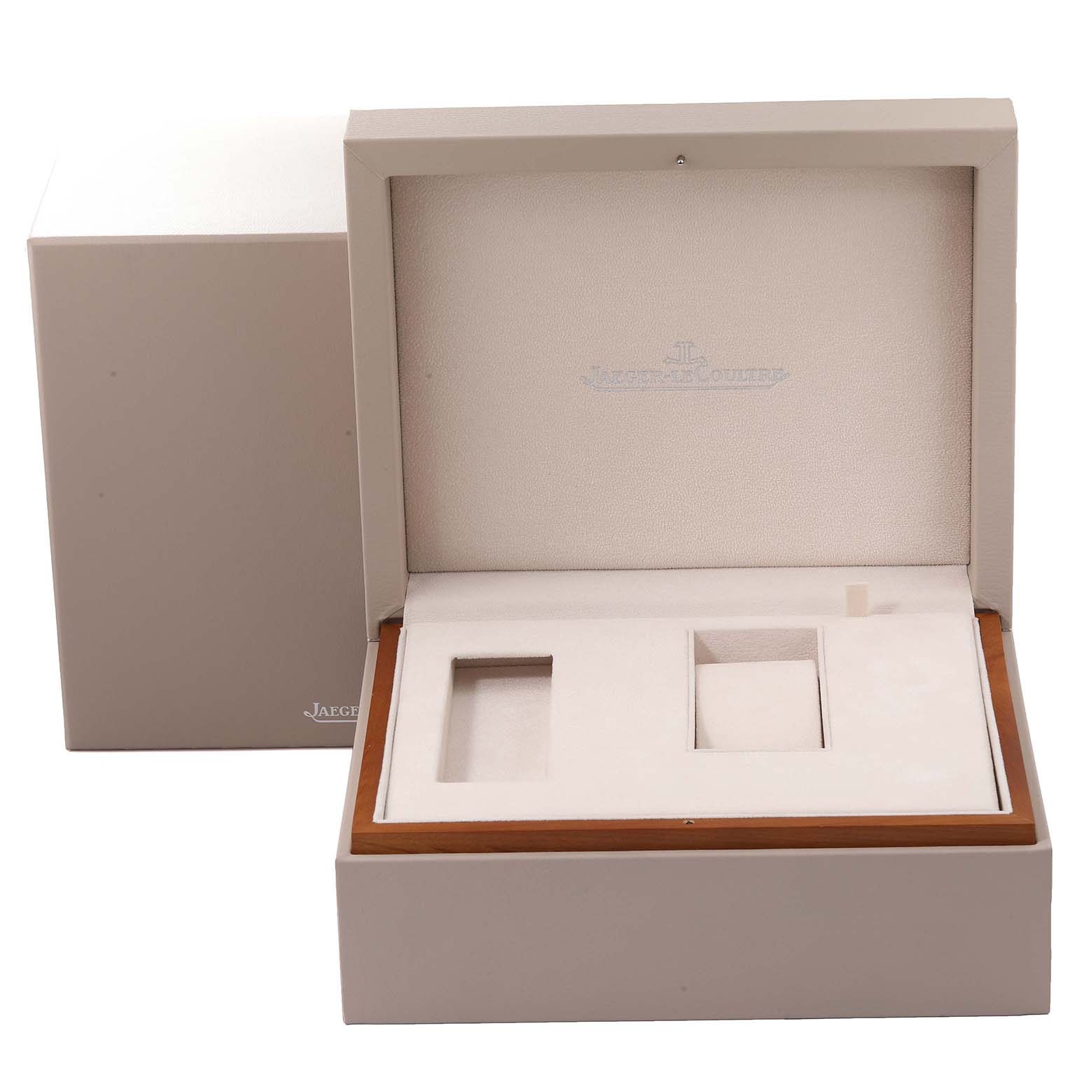 The image shows an open watch box for the Jaeger-LeCoultre Reverso model, displaying multiple compartments.