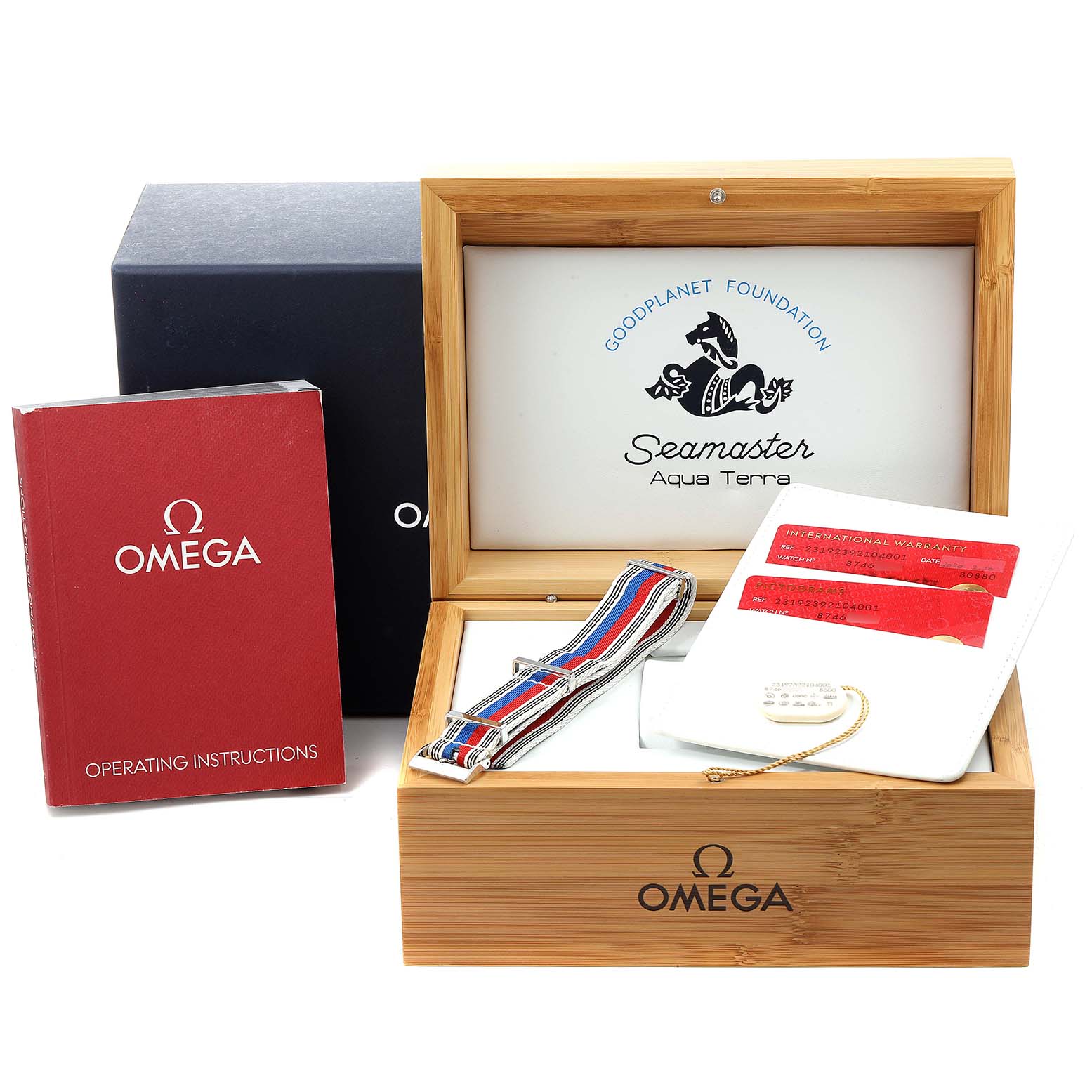 The image shows the Omega Aqua Terra 231.92.39.21.04.001  Men's Titanium White Dial 231.92.39.21.04.001  Men's Titanium White Dial watch accessories at a front angle, featuring the box, operating instructions, and a NATO strap.