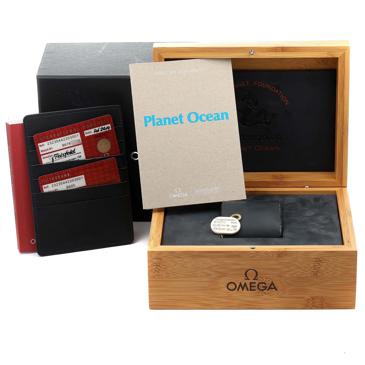 The image shows the Omega Planet Ocean 232.30.44.22.03.001 Men's Stainless Steel Blue Dial 232.30.44.22.03.001 Men's Stainless Steel Blue Dial watch accessories, including a wooden box, certificates, and warranty cards.