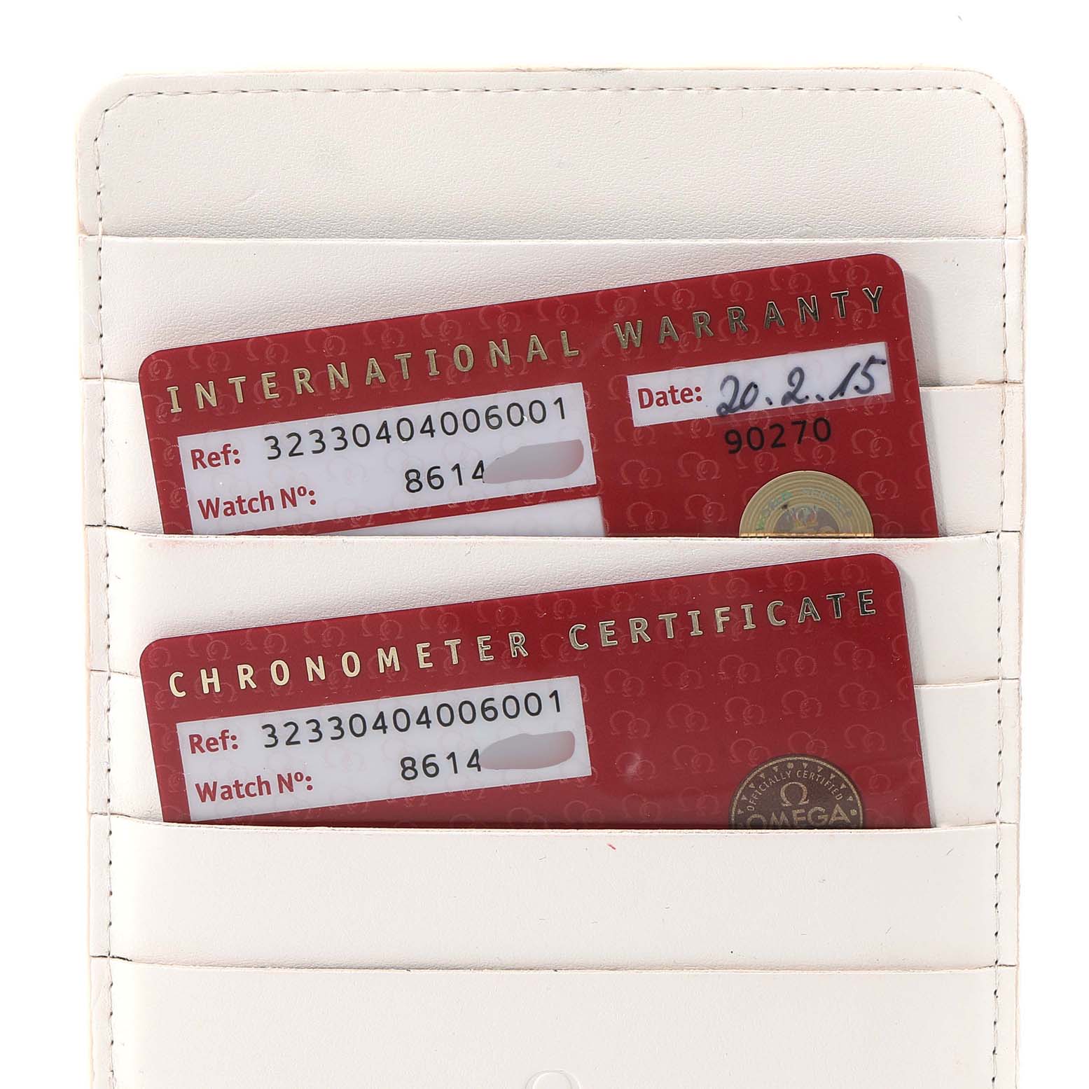 The image shows the warranty and chronometer certificate cards for the Omega Speedmaster 323.30.40.40.06.001 Men's Stainless Steel Grey Dial 323.30.40.40.06.001 Men's Stainless Steel Grey Dial model in a white cardholder.
