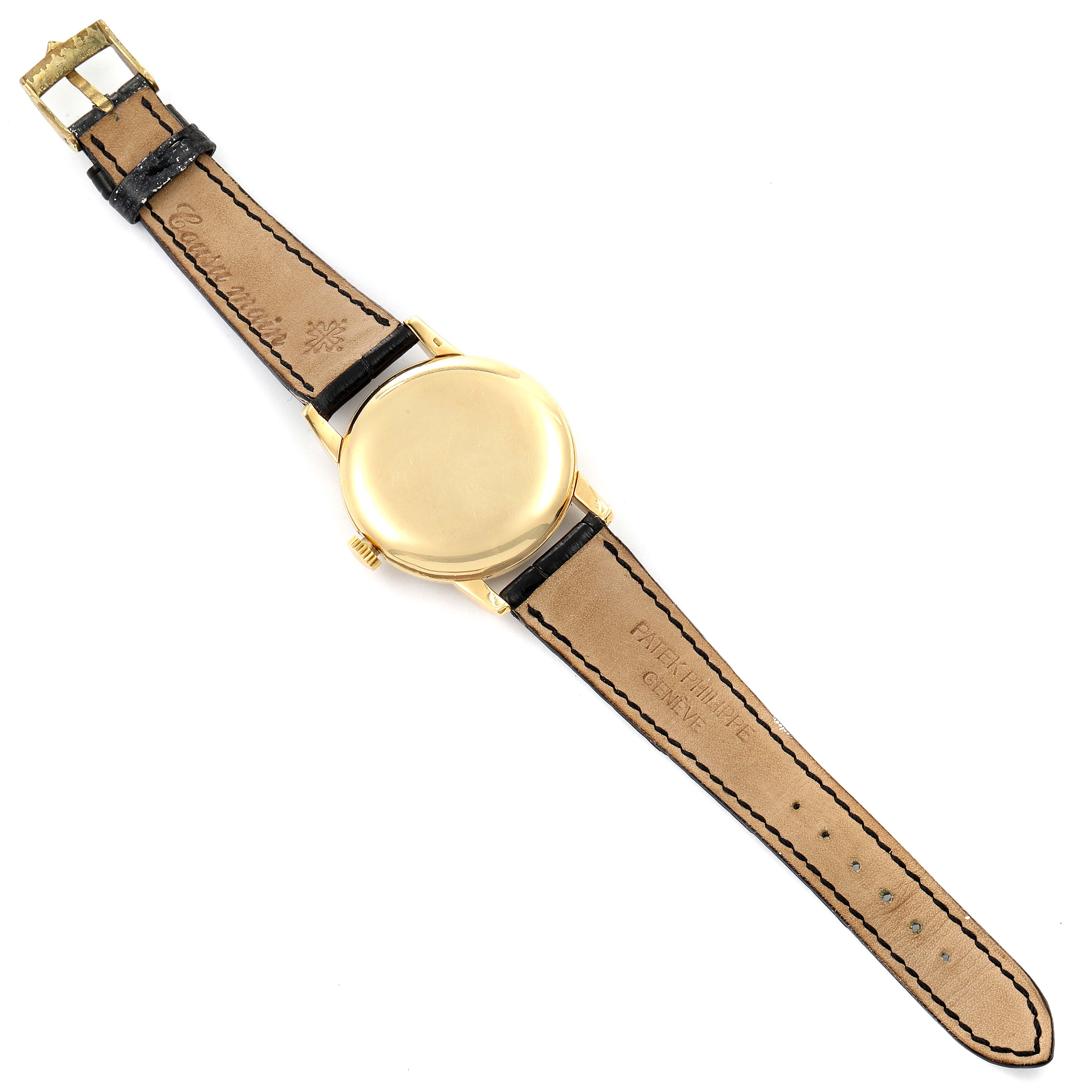 This image shows the back casing, crown, and strap (inside view) of a Vintage Patek Philippe watch.