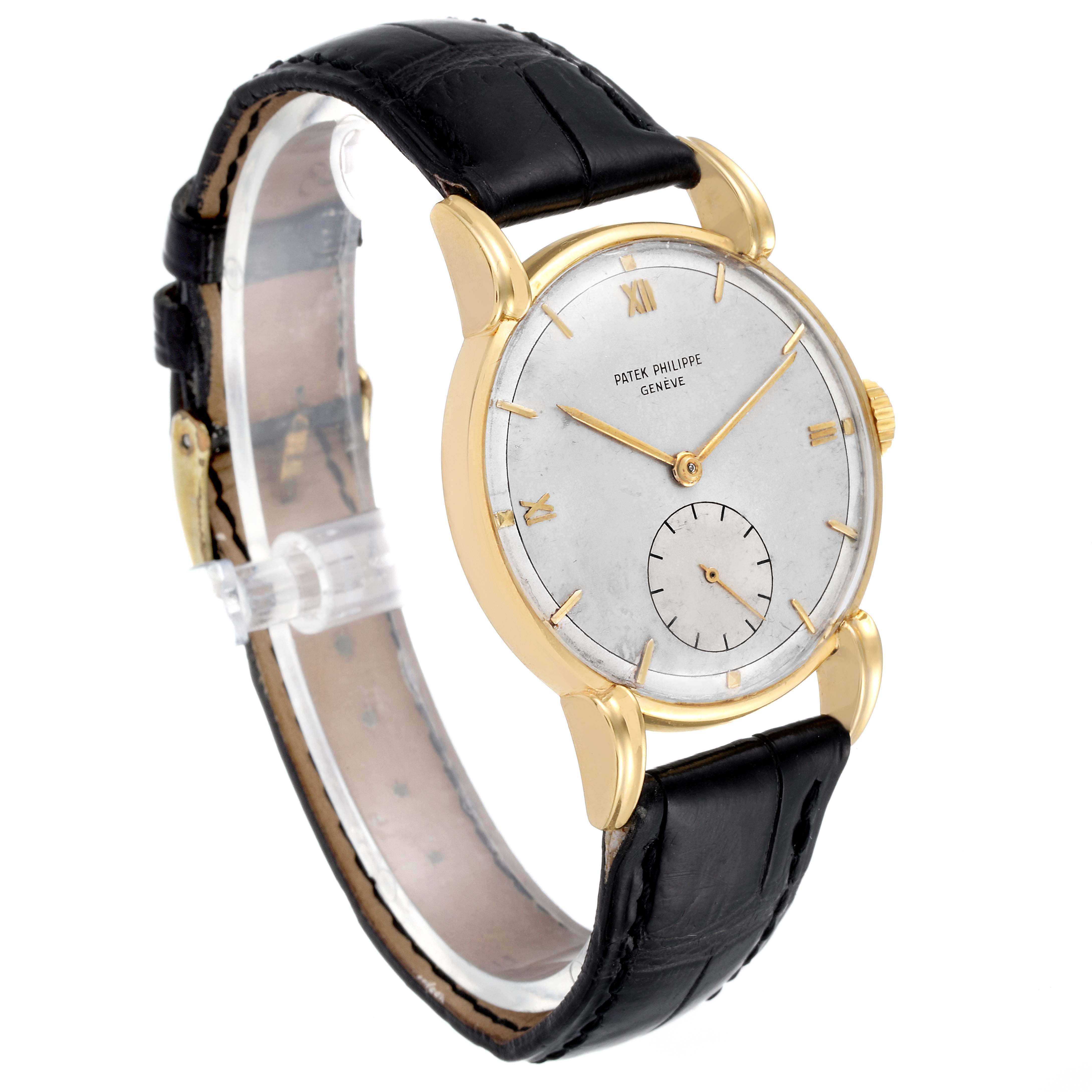 The image shows a side angle of a Vintage Patek Philippe watch highlighting its gold case, dial, and black leather strap.