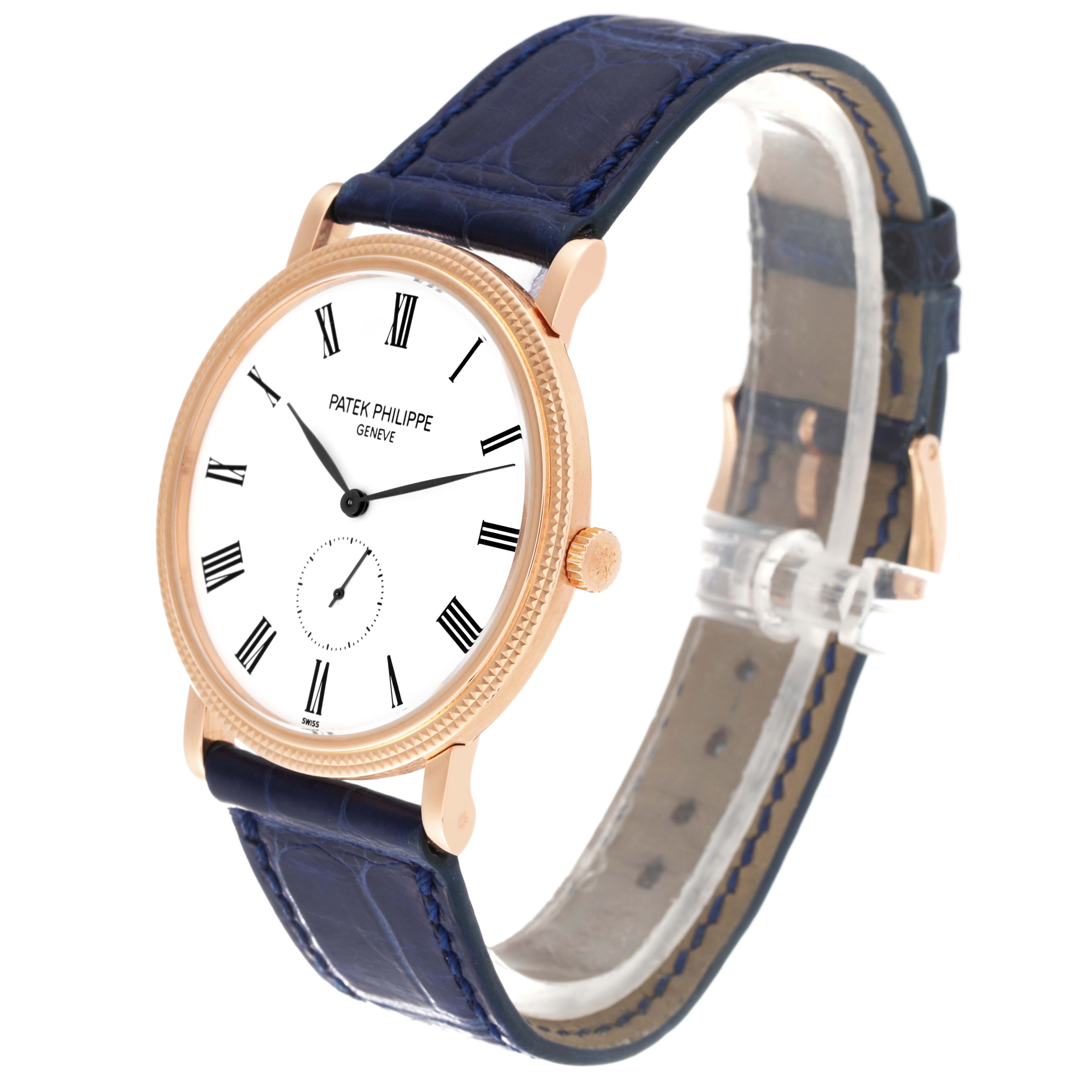 The image shows a side angle of the Patek Philippe Calatrava 5119R Men's Rose Gold White Dial 5119R Men's Rose Gold White Dial watch, highlighting its white dial, gold casing, blue leather strap, and crown.
