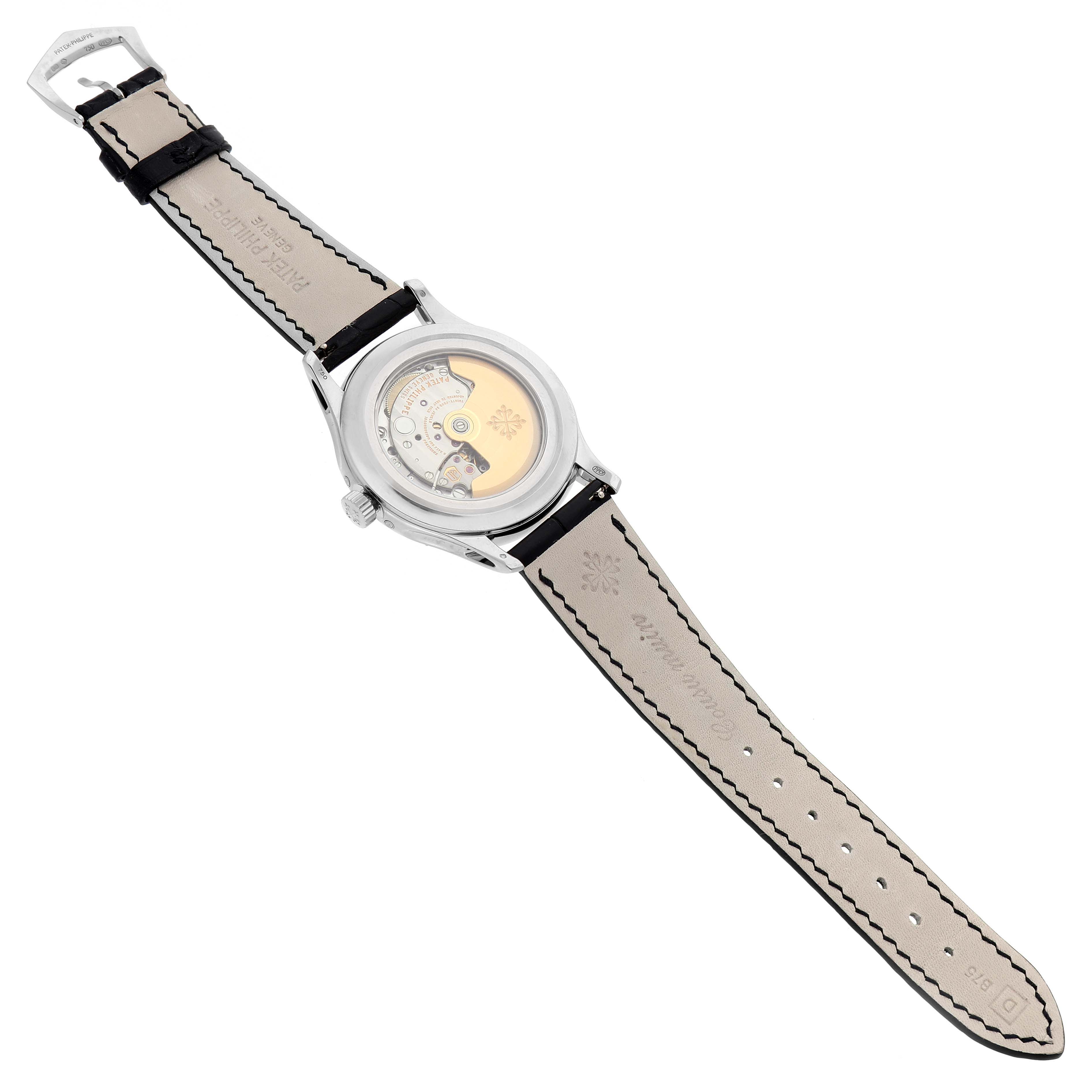 The image shows a Patek Philippe Complications 5205G-010 Men's White Gold Grey Dial watch from the rear, displaying its movement and leather strap.