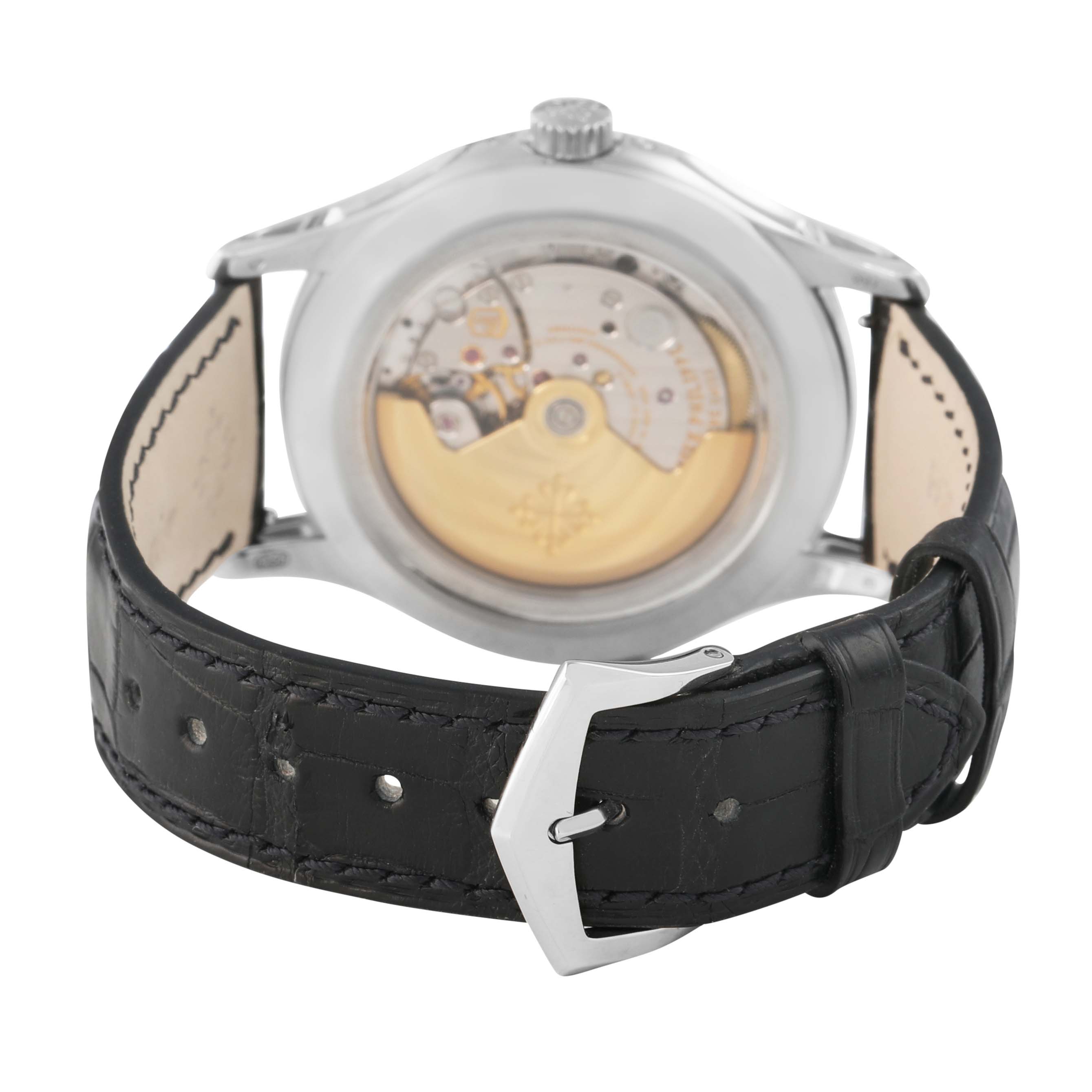 The Patek Philippe Complications 5205G-010 Men's White Gold Grey Dial watch is shown from the back, displaying the case back, movement, and leather strap with buckle.