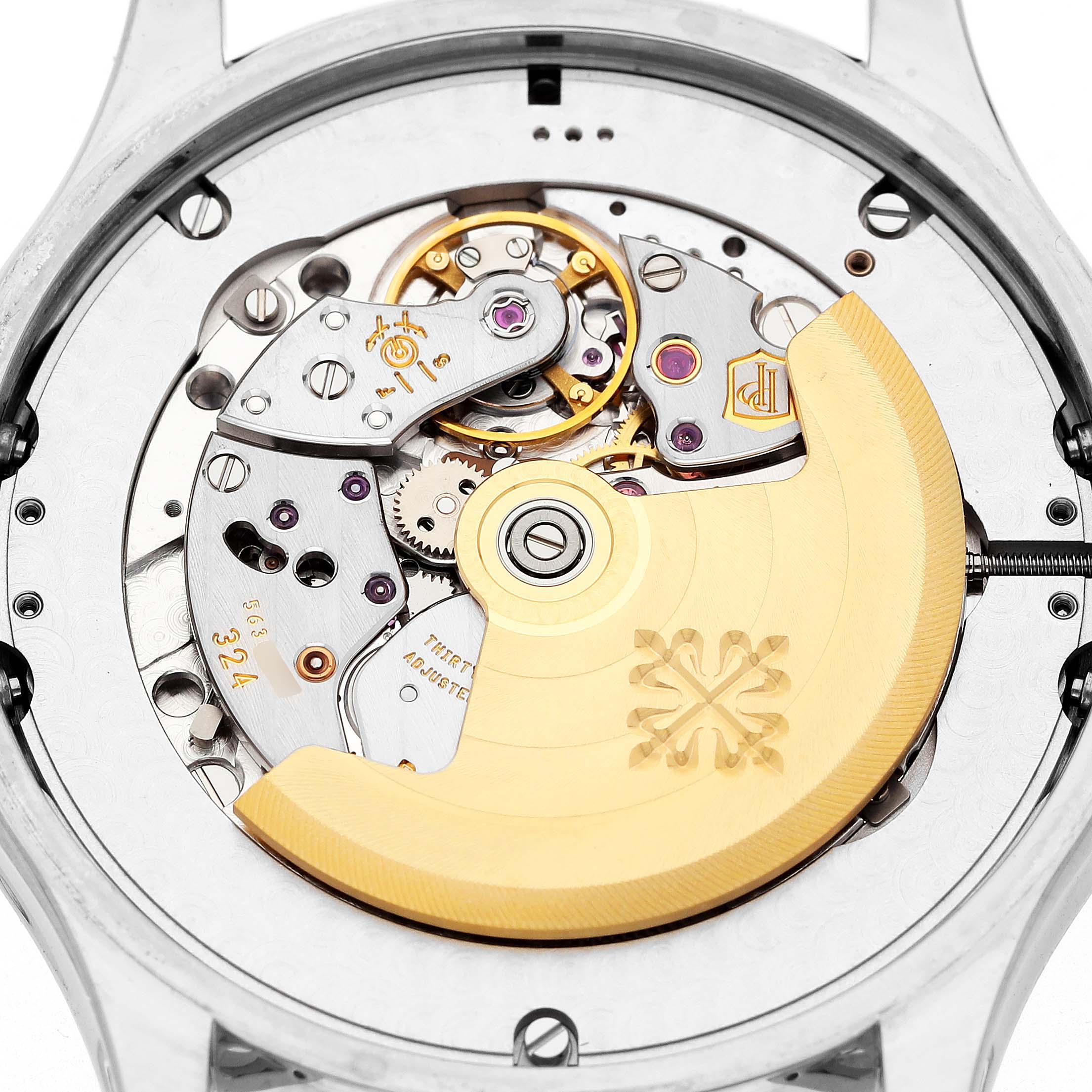 The image shows the intricate back movement of the Patek Philippe Complications 5205G-010 Men's White Gold Grey Dial model watch, highlighting gears and the rotor.