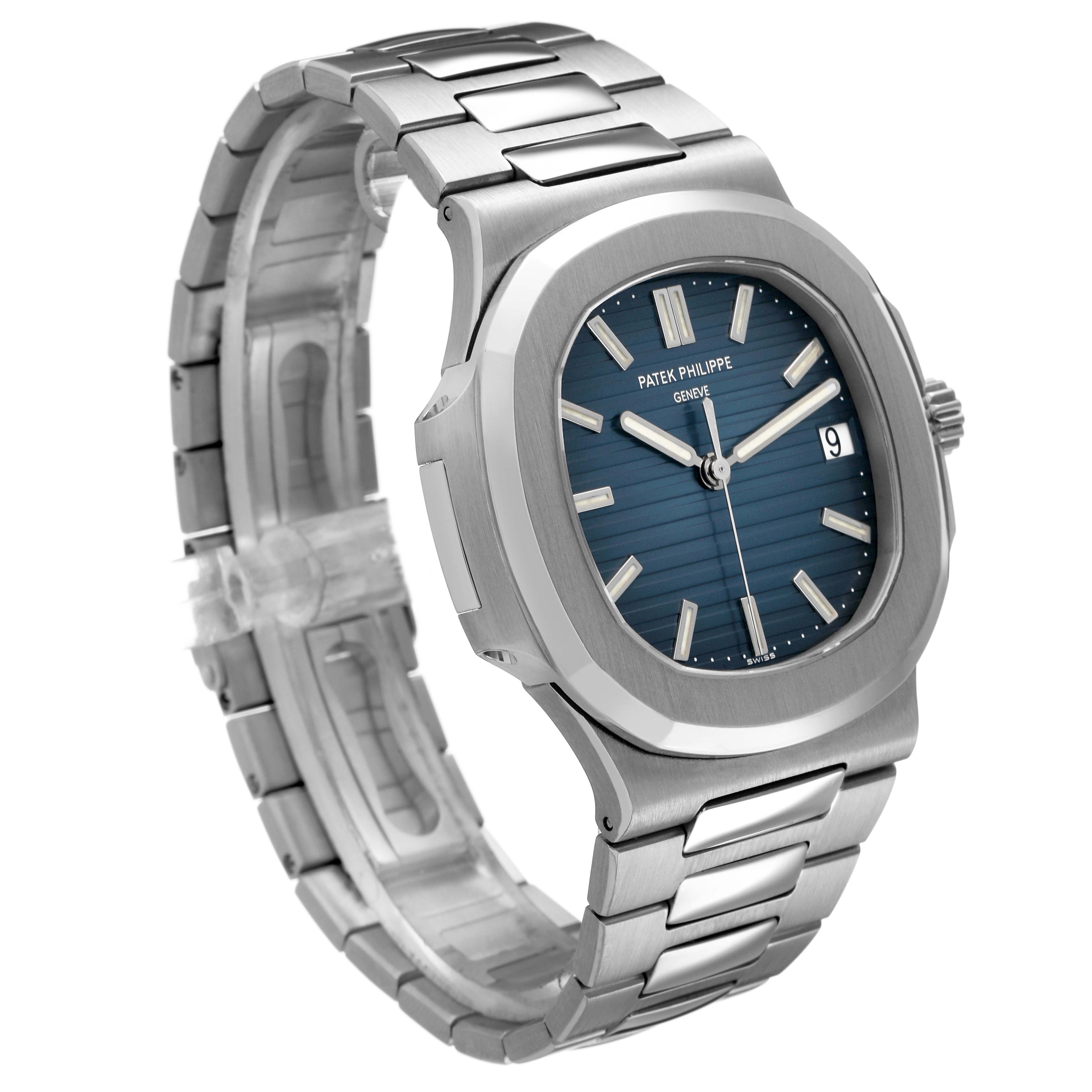 The Patek Philippe Nautilus 5711/1A-001 Men's Stainless Steel Blue Dial watch is shown at a three-quarter angle, displaying its blue dial, hands, and metal bracelet.