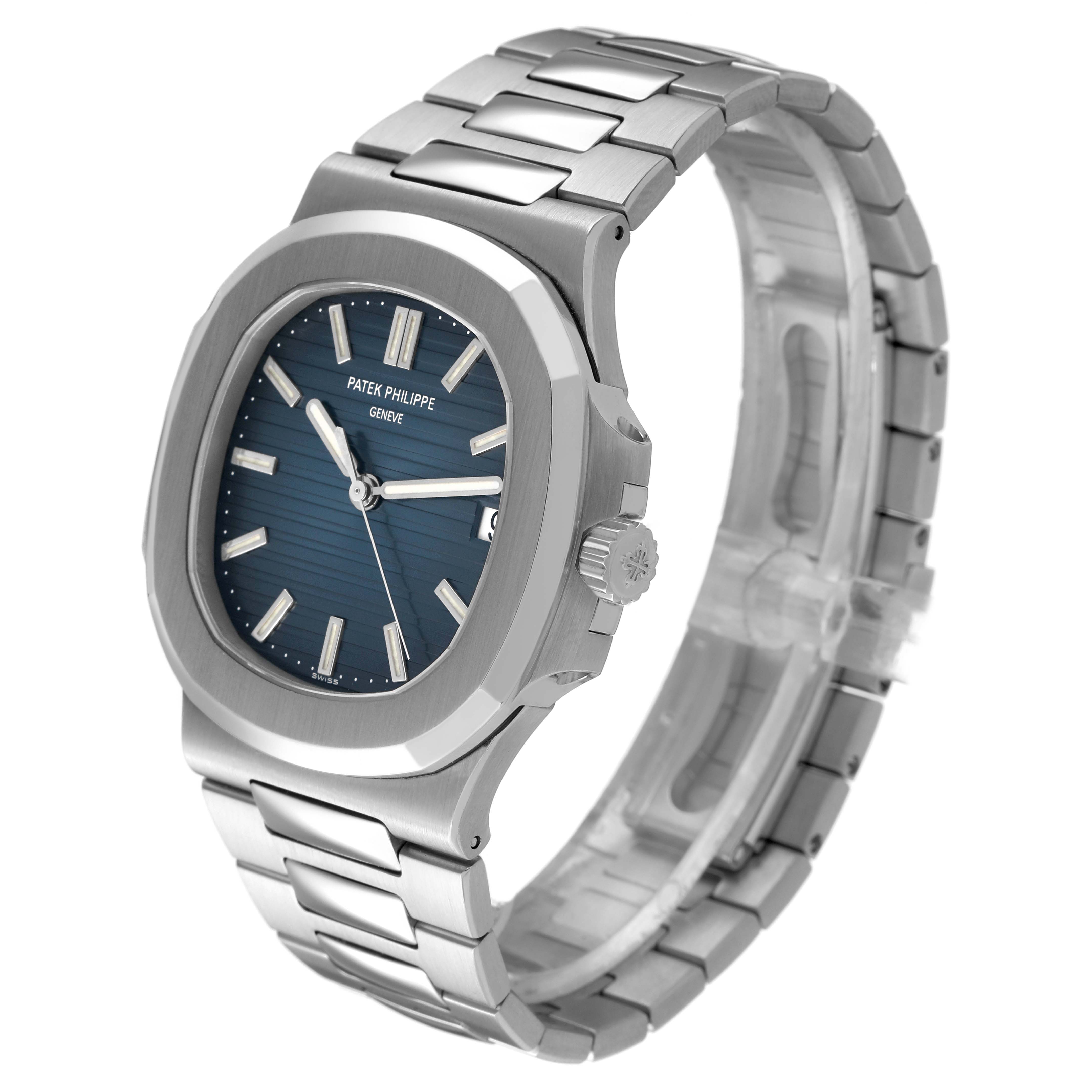 The Patek Philippe Nautilus 5711/1A-001 Men's Stainless Steel Blue Dial watch is shown at an angle highlighting the face, bezel, crown, and bracelet.