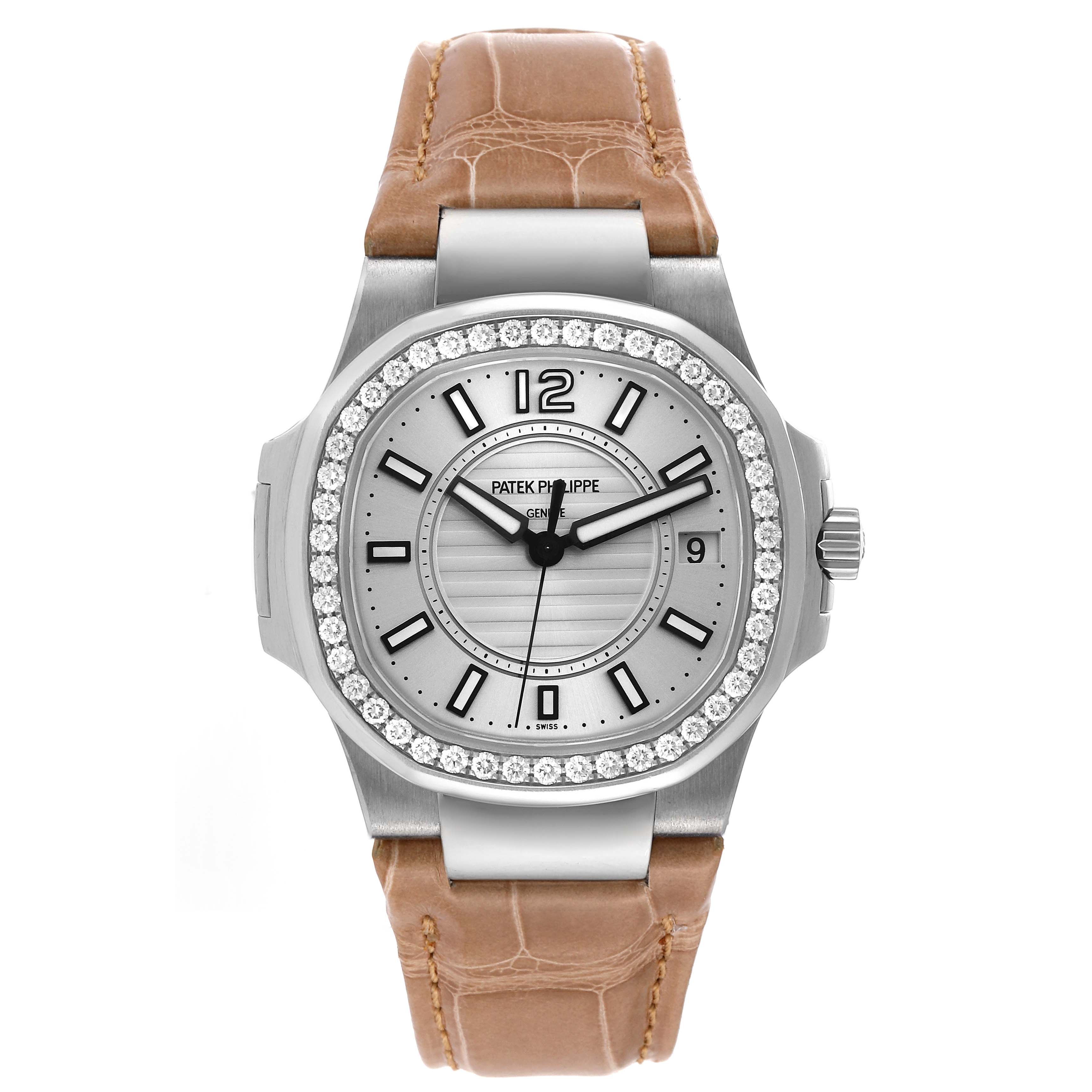 The image shows a front view of the Patek Philippe Nautilus 7010G Women's White Gold Silver Dial 7010G Women's White Gold Silver Dial watch, featuring a diamond bezel and a brown leather strap.